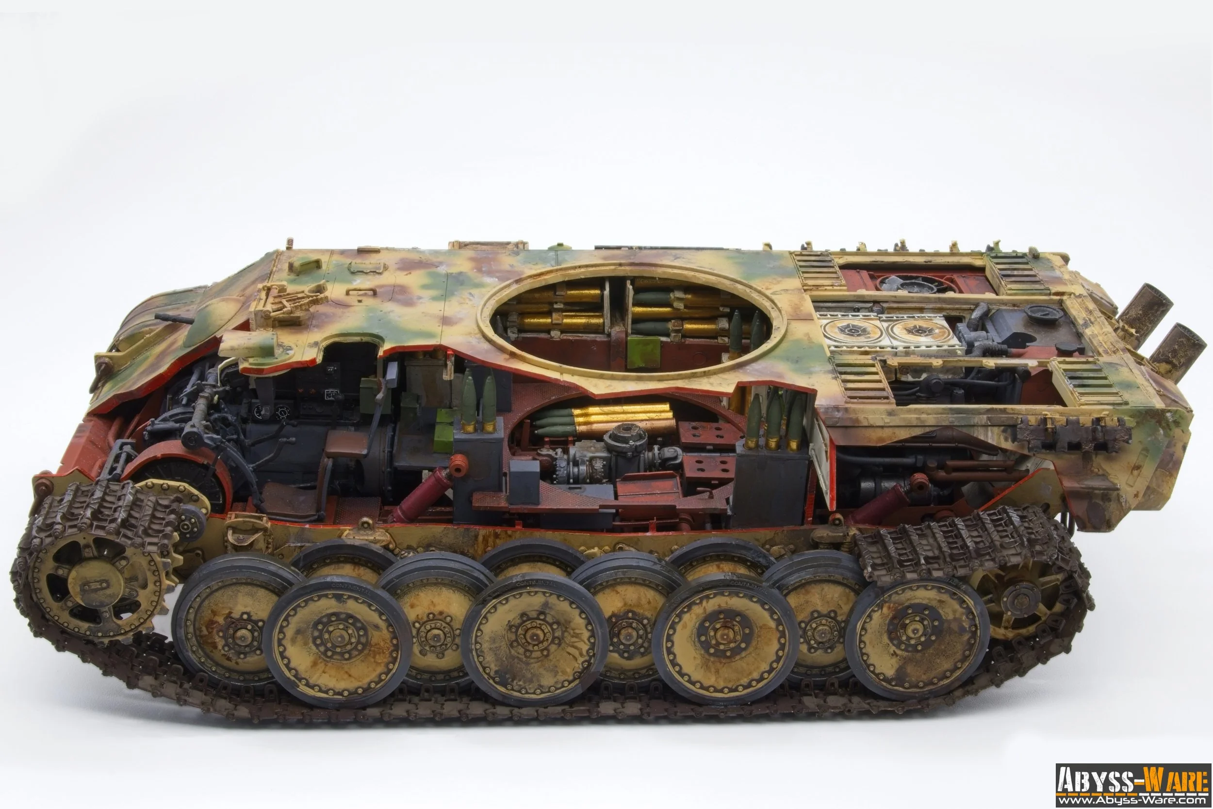 A detailed model of a military tank with camouflage paint and visible internal components such as gears, machinery, and tracks, placed on a plain white background.