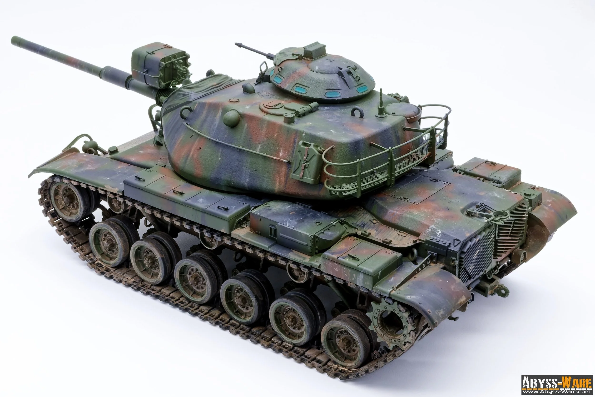 A detailed scale model of a military tank with a camouflage paint scheme, featuring a large gun barrel, turret, and realistic tracks.