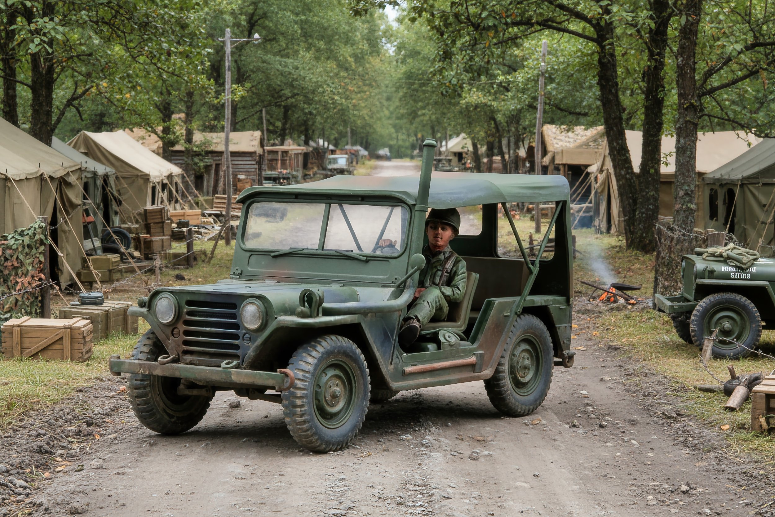 A vintage military scene with a person sitting in a green military vehicle on a dirt road, surrounded by tents and trees, suggesting a historical or outdoor reenactment setting.