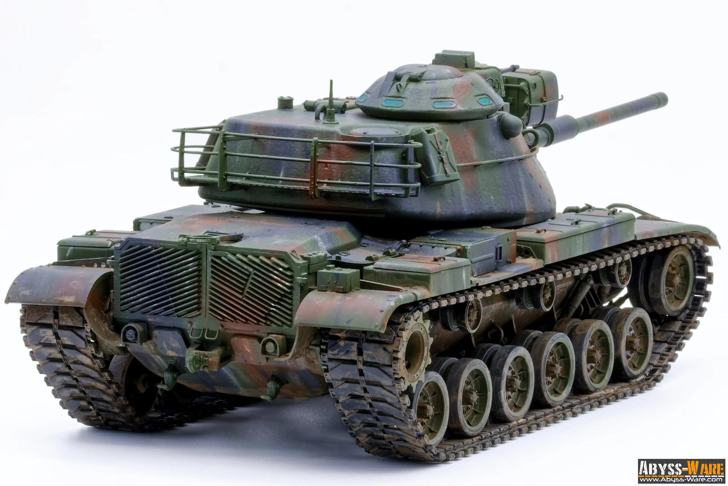 A detailed model of a military tank with camouflage paint, positioned on a white background.