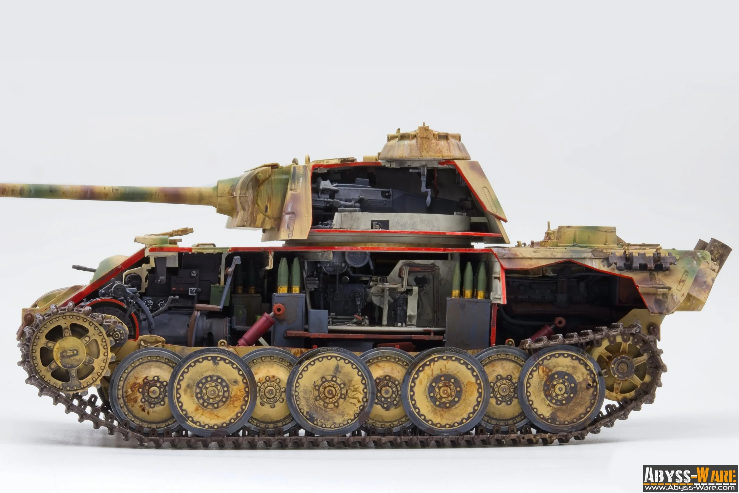 Cross-section of a military tank showing internal components, with camouflage exterior paint, set against a plain white background.