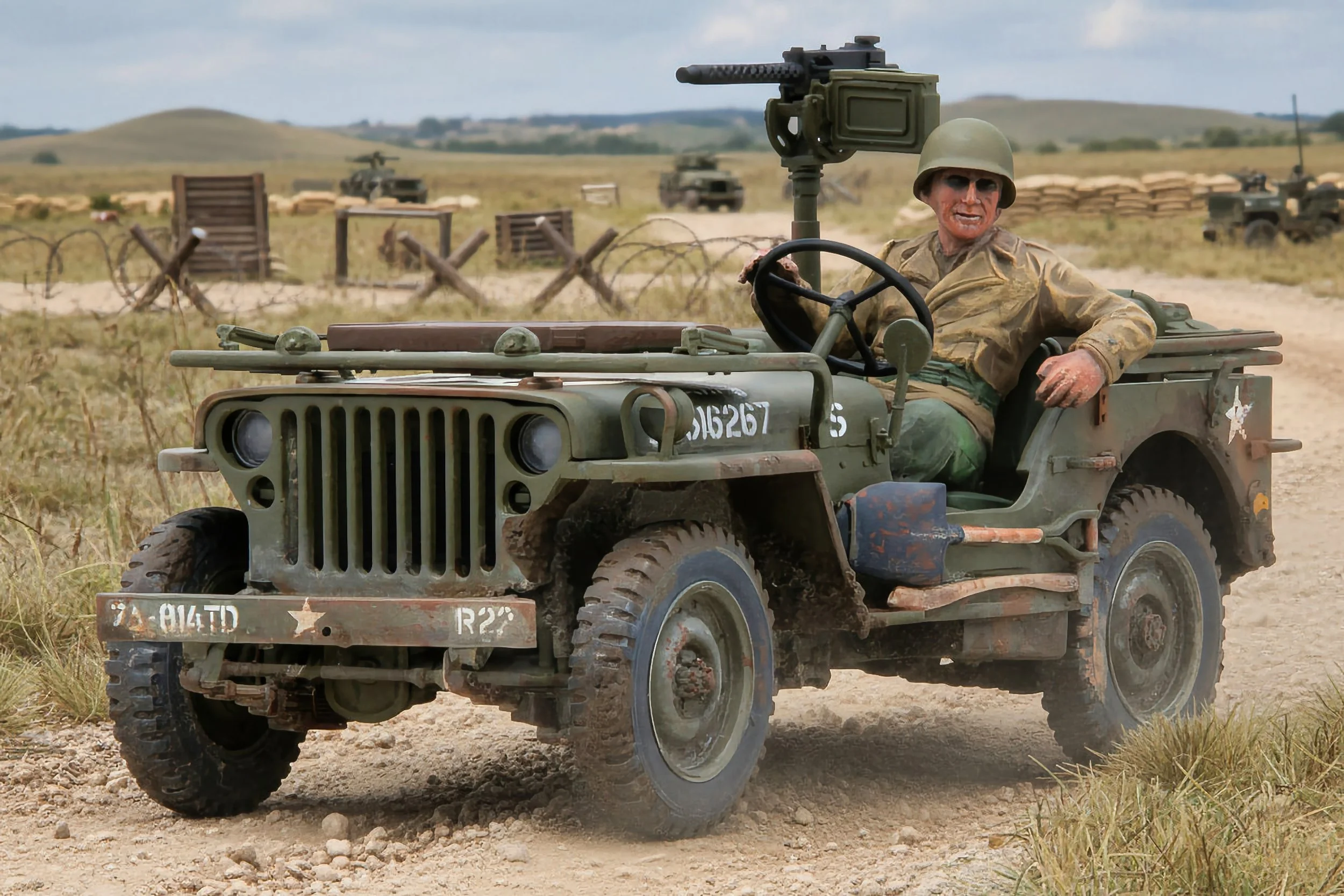 A military jeep with a soldier, armed with a mounted machine gun, driving through a dusty field during daytime with hills and barbed wire fences in the background.