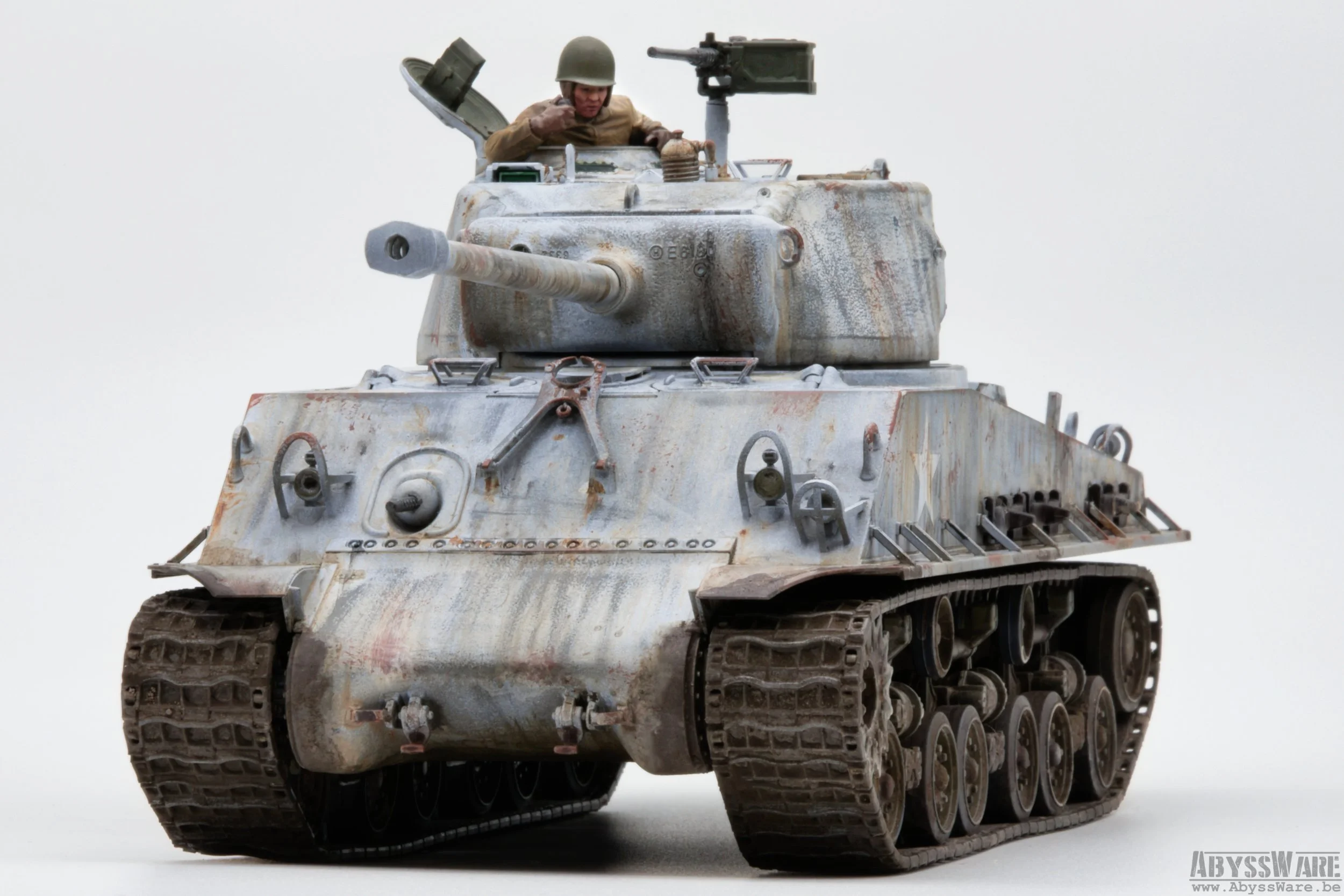 A model of a military tank with a soldier figure in the turret, against a plain white background.