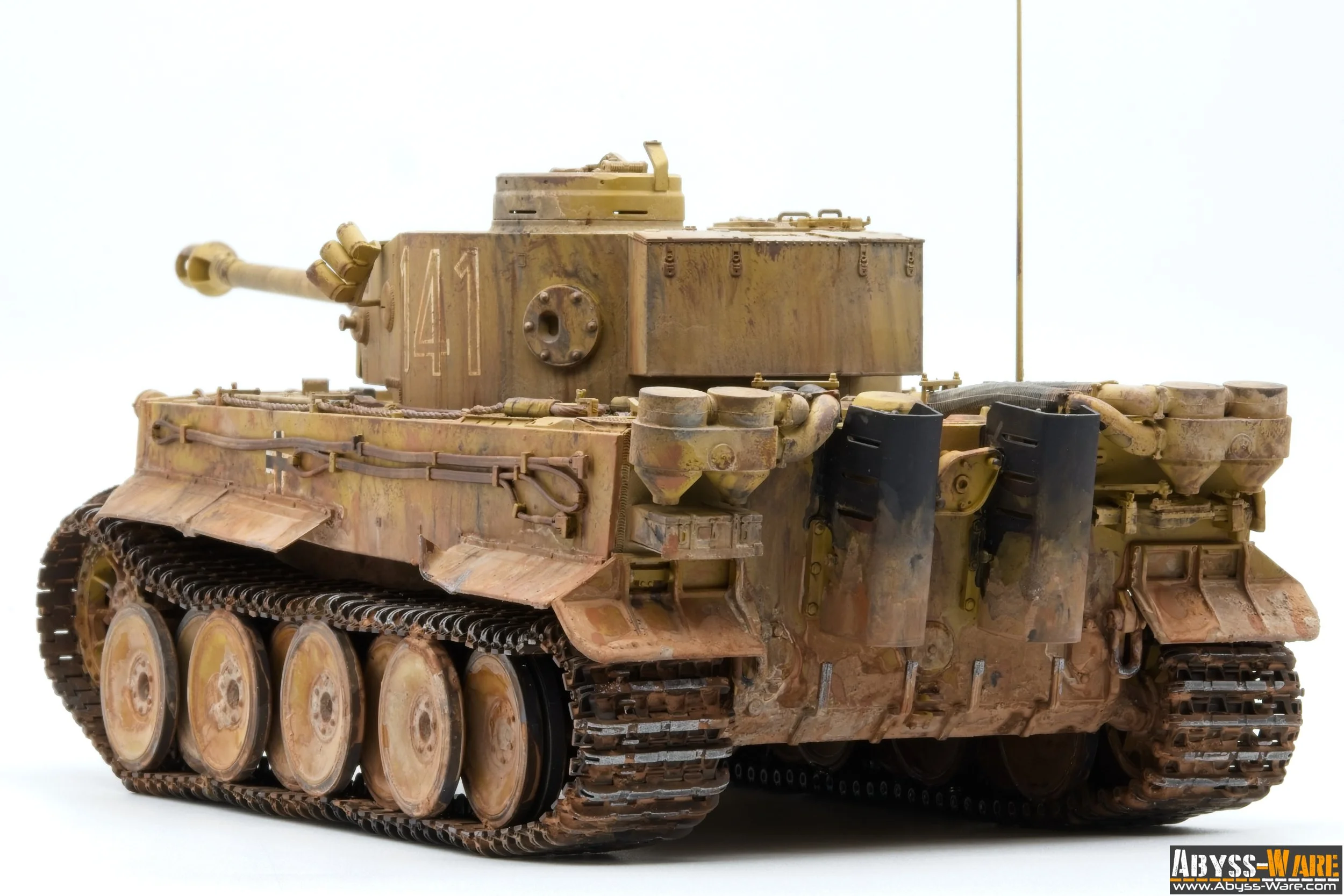 Model of a military tank with weathered, desert camouflage paint, and visible treads and cannon on a plain white background.