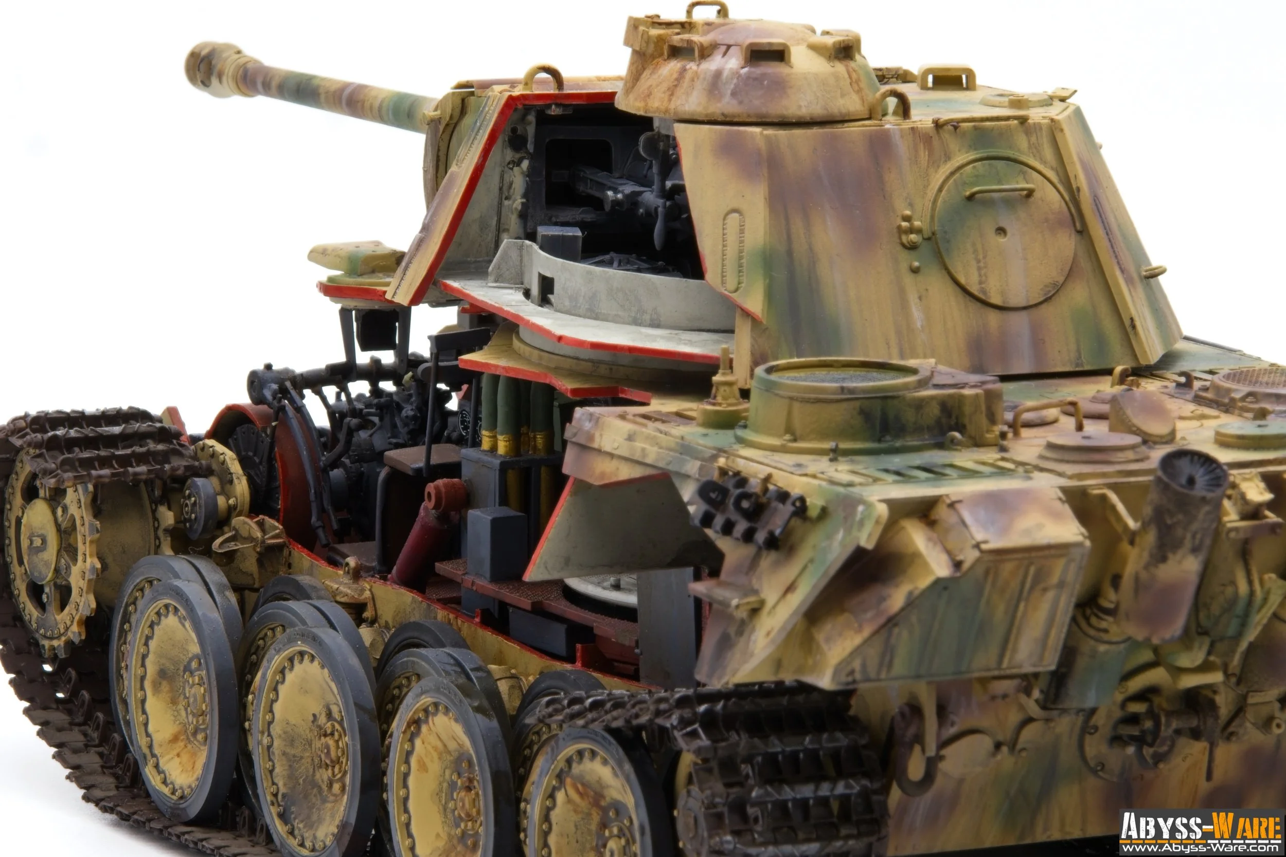 Model of a military tank with a camouflage paint job, showing internal details and machinery parts.