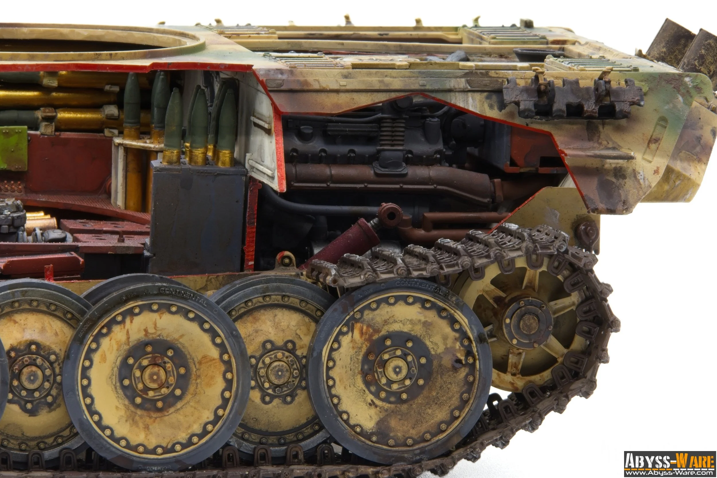 Close-up image of a detailed model or replica of a military tank's tracked wheel system, showing rust and weathering effects.