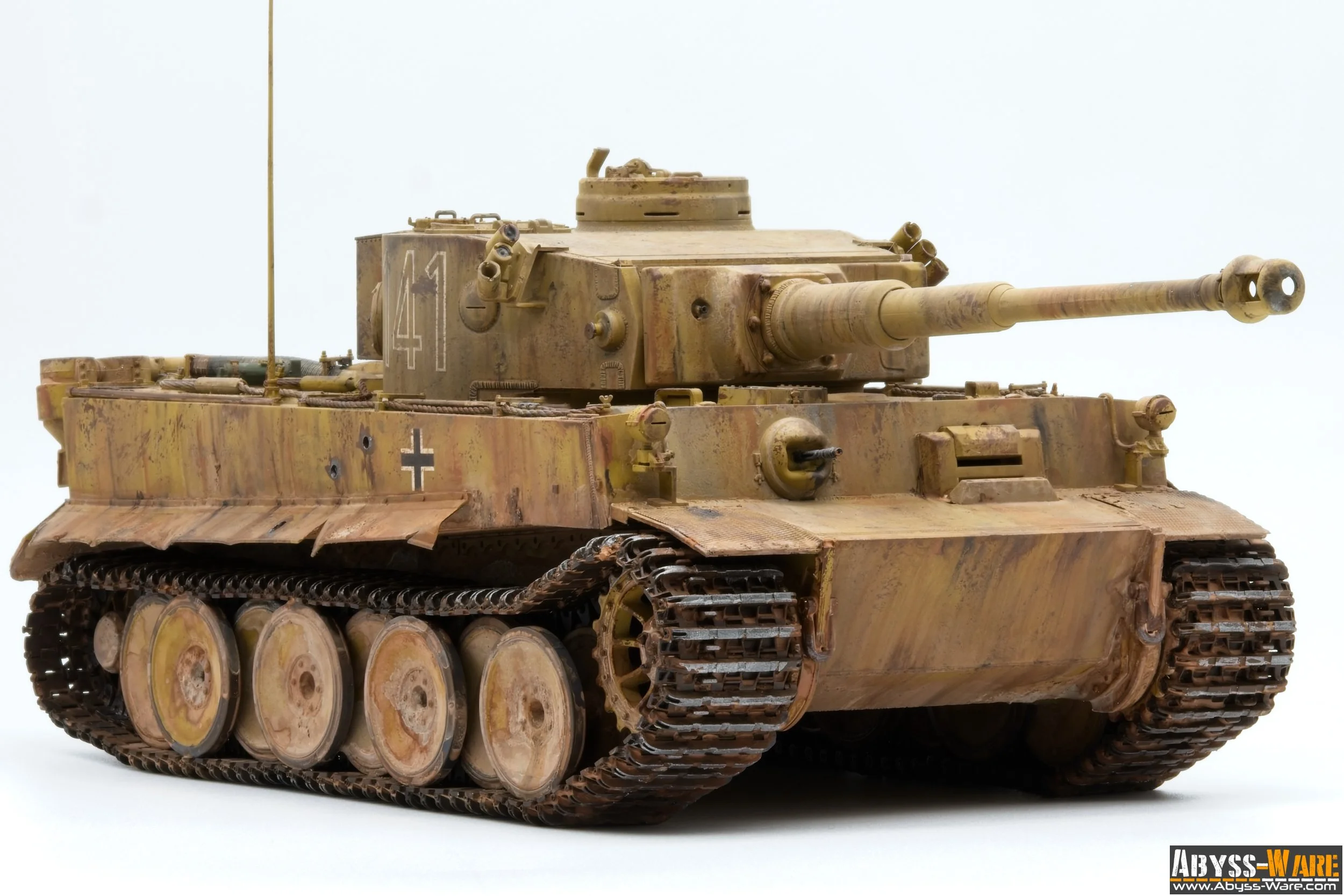 Model of a military tank with beige and brown camouflage, featuring a turret with a long barrel, tracked wheels, and German military insignia on the side.