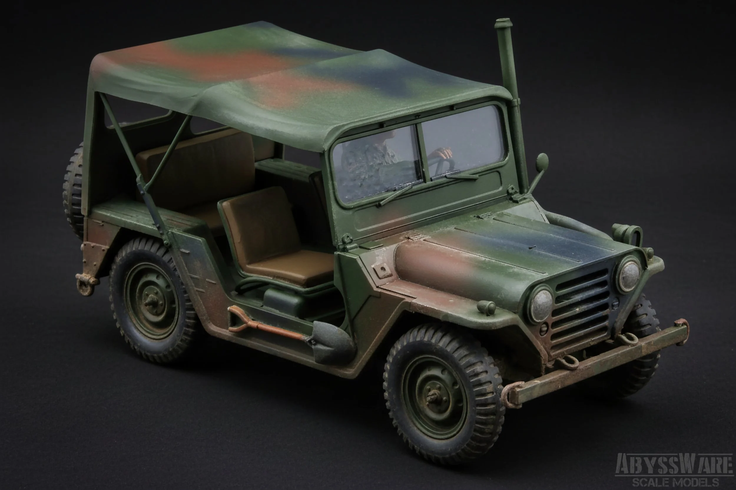 A scale model of a military Jeep with a camouflage paint job and beige seats on a black background.