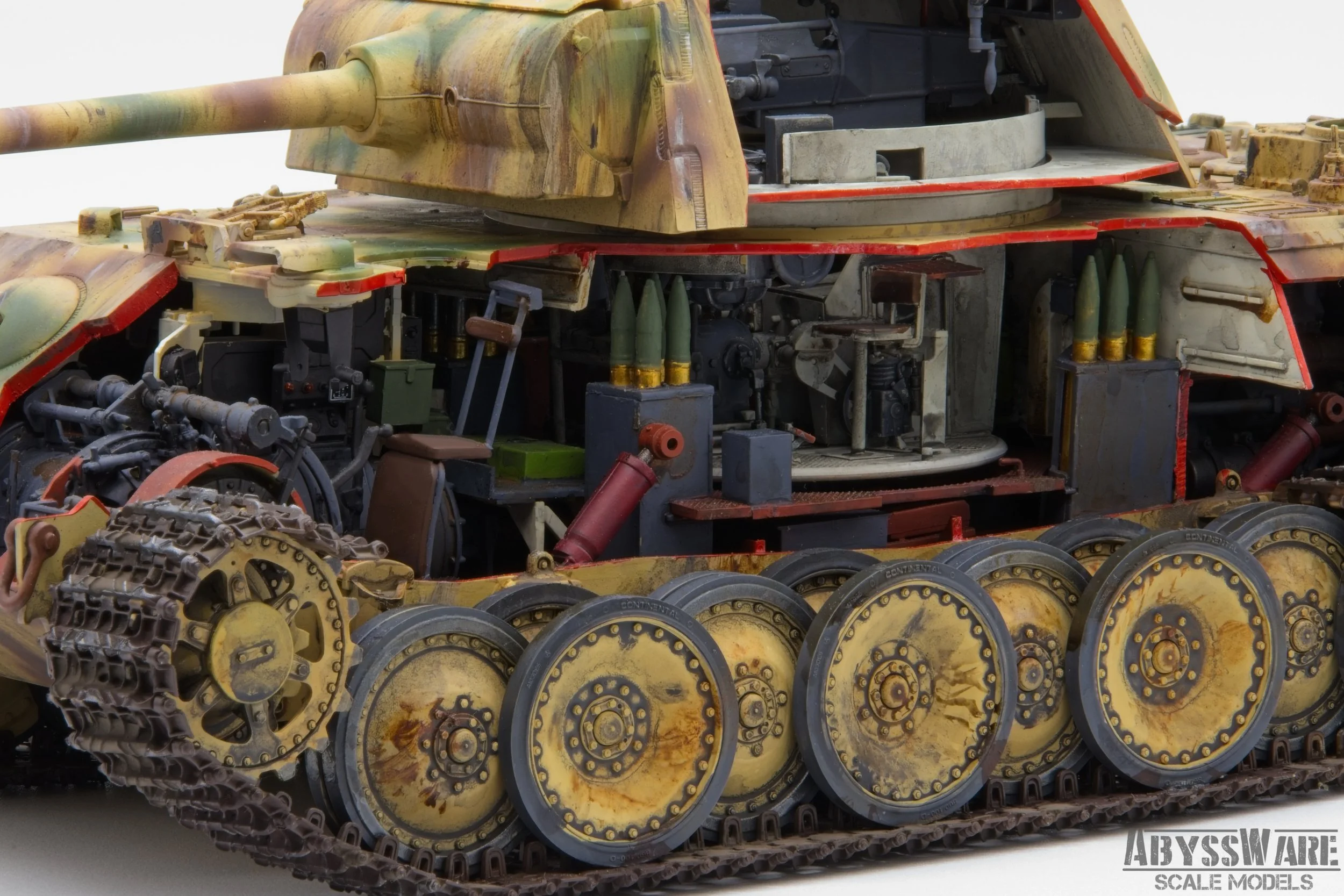 A detailed model of a tank with exposed internal components, gun barrel, armor, and tracks, showing internal machinery and ammunition containers.