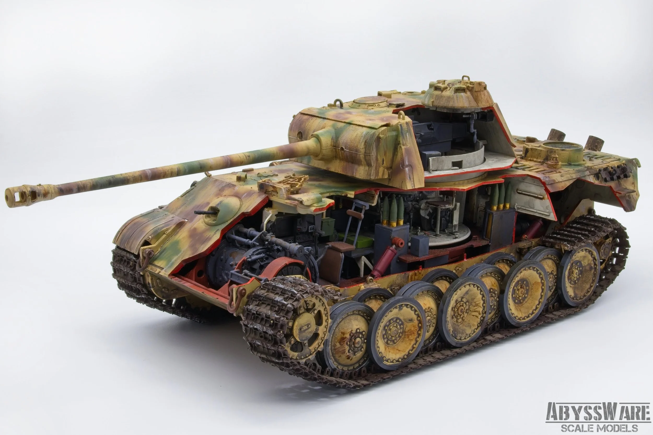 A detailed scale model of a military tank with camouflage coloring, showing internal mechanical parts and tracks.