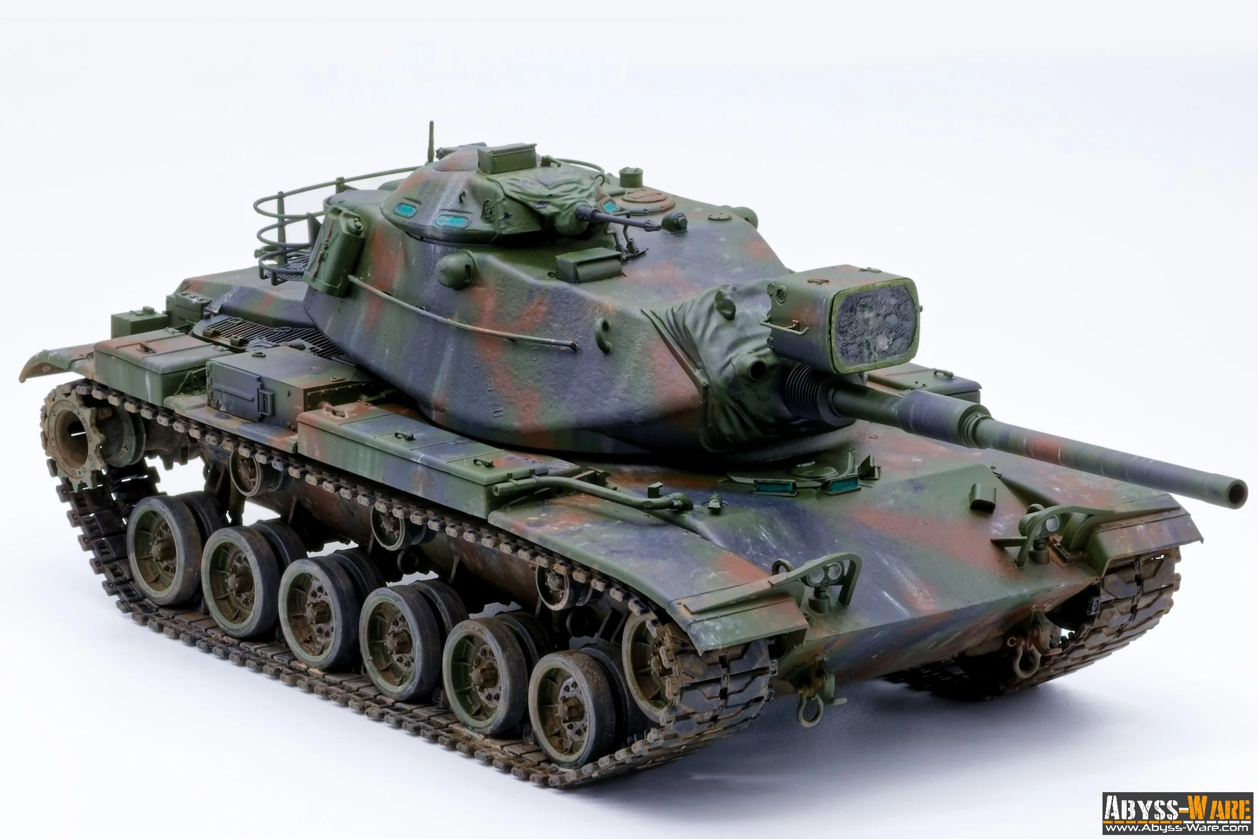 Model of a military tank with green and brown camouflage pattern, detailed with various equipment and markings, placed on a white background.
