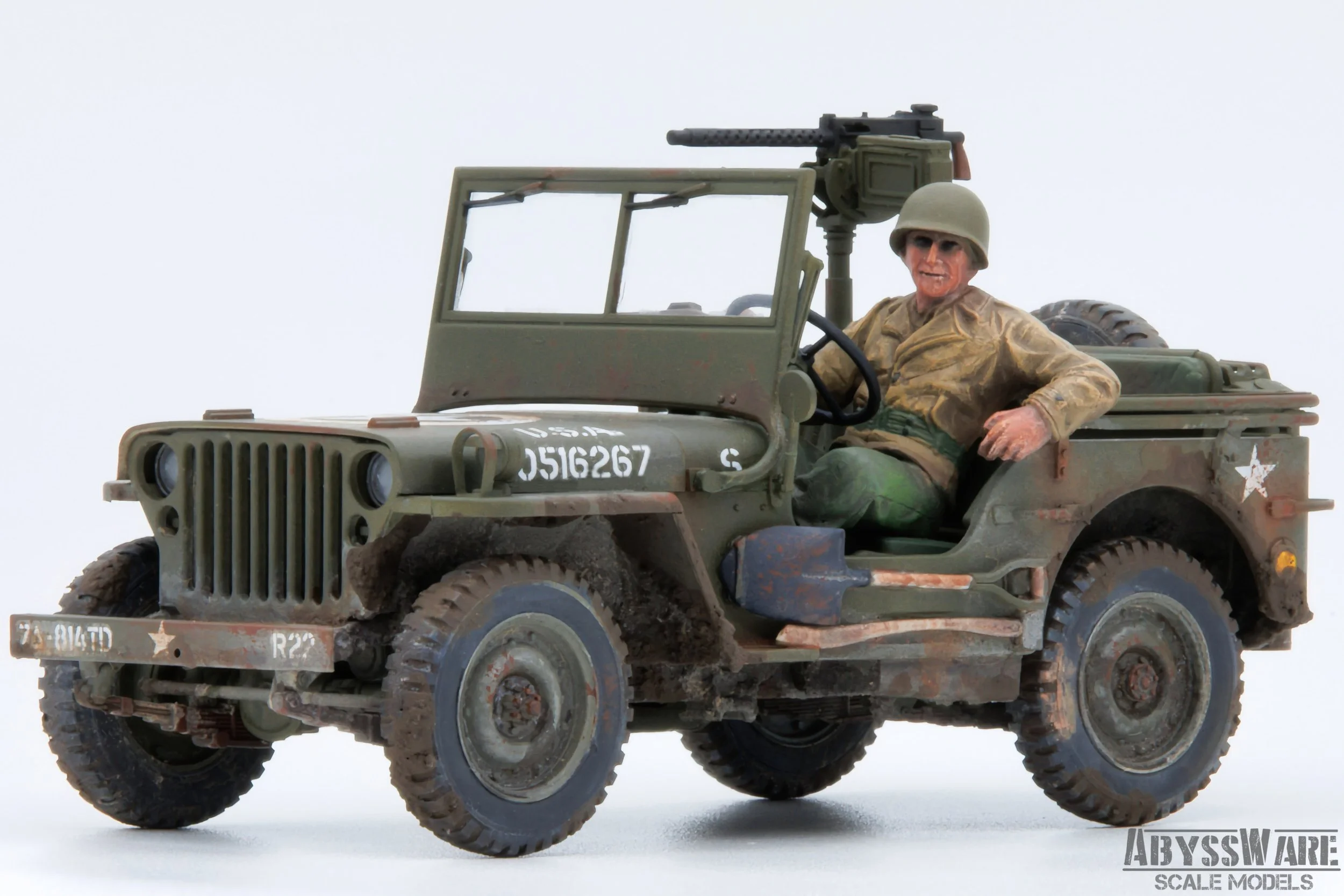 A miniature scale model of a military Jeep with a soldier figure sitting inside, wearing a helmet and camouflage uniform. The vehicle is weathered with dirt and rust details, and has a mounted machine gun on the back. The background is plain white.