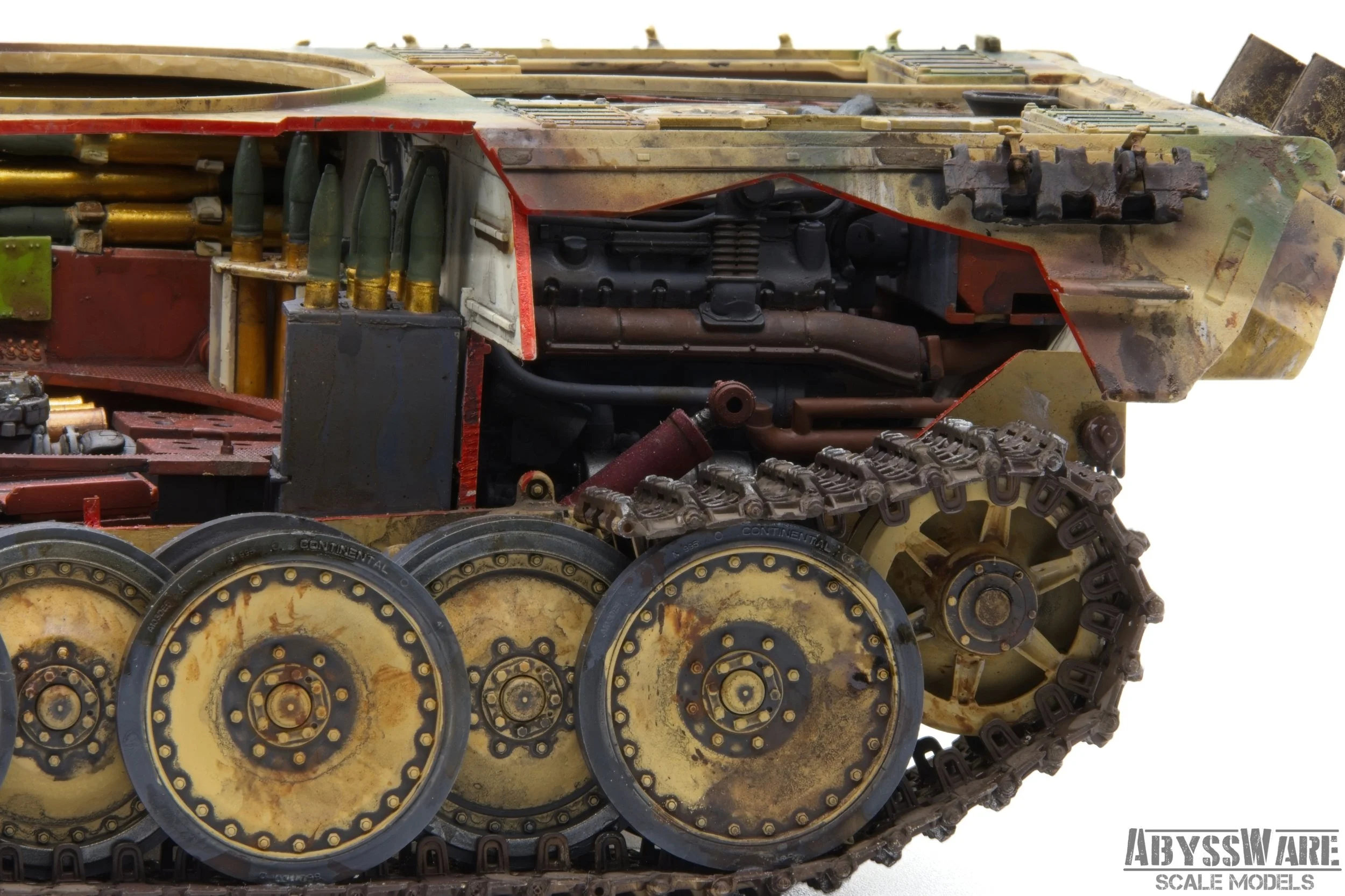 Close-up of a detailed scale model of a military tank's side showing wheels, tracks, and internal mechanical components.