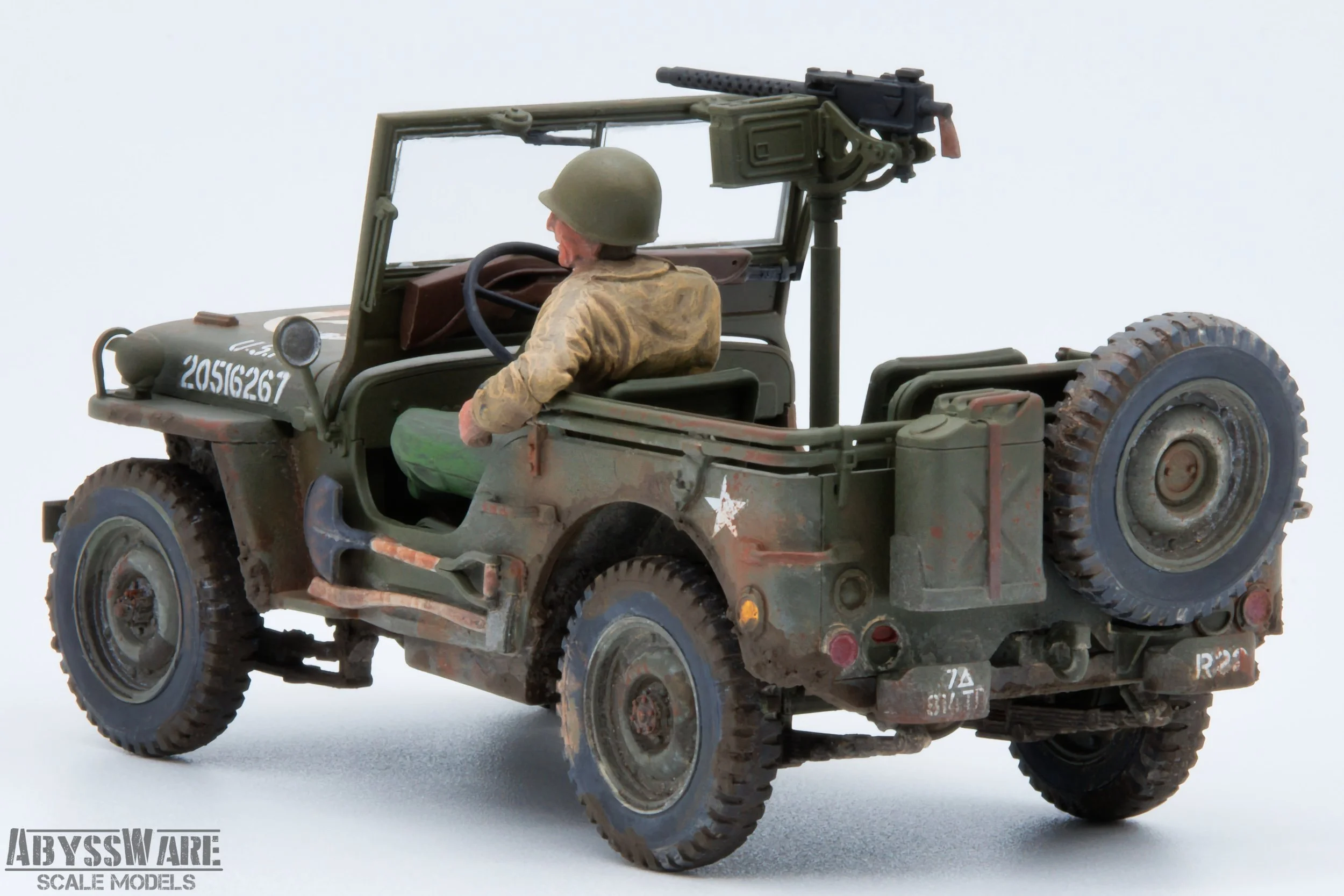 Scale model of a military Jeep with a soldier figure and mounted machine gun, painted in camouflage, with weathering effects.
