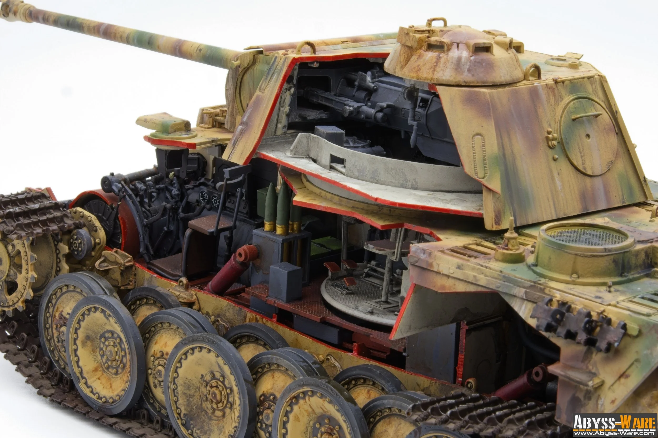 Close-up view of a partially assembled military tank model, displaying detailed internal and external components including the treads, wheels, and internal machinery