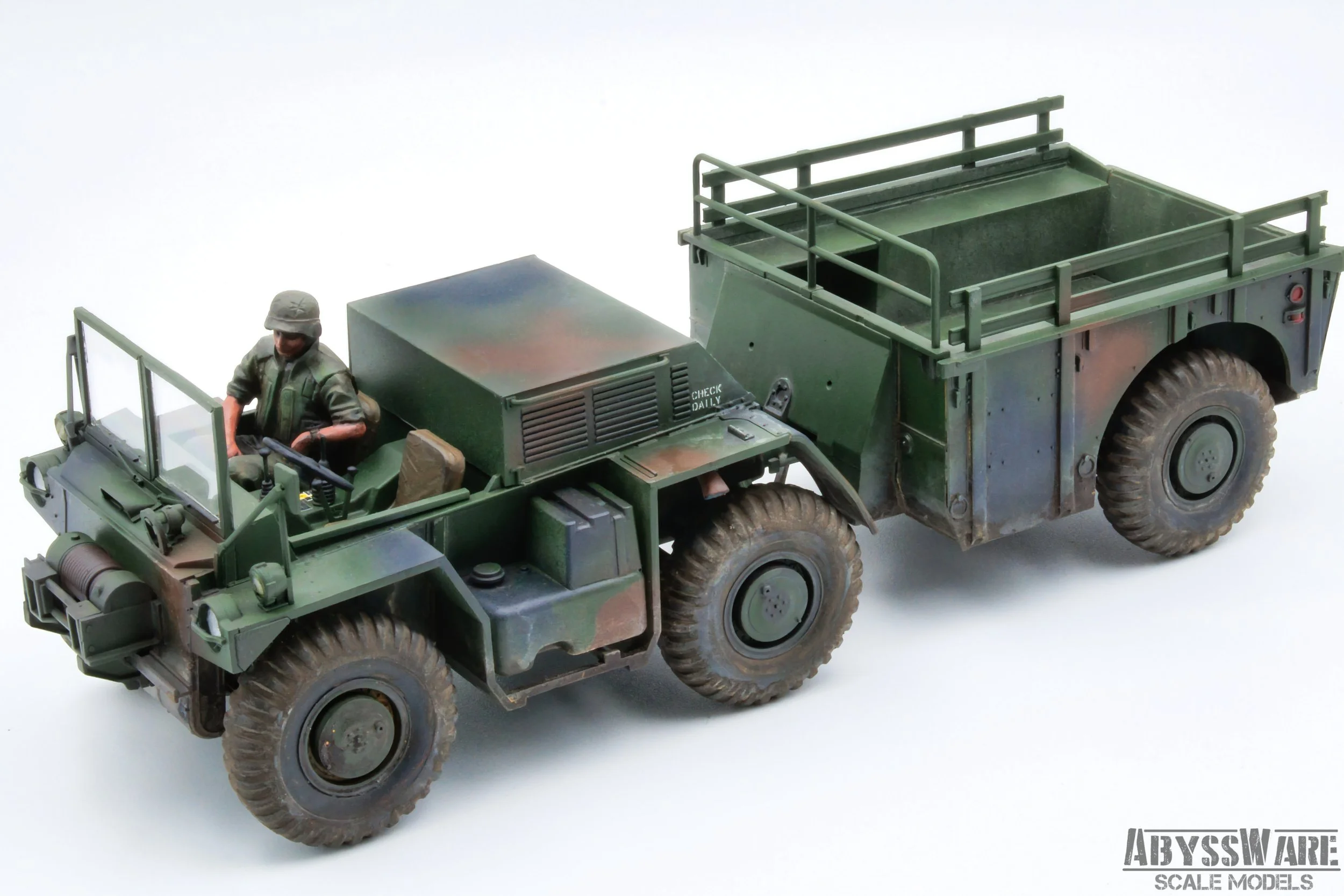 A scale model of a military truck with a figure of a soldier in the driver's seat, painted in camouflage colors, with the logo 'ABYSSWARE SCALE MODELS' in the bottom right corner.