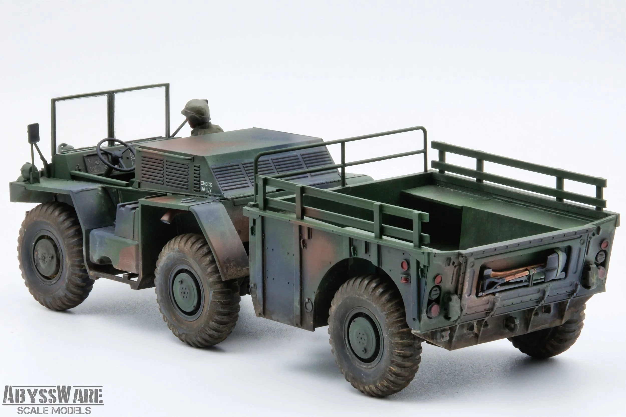 Miniature model of a military vehicle, a green off-road truck with a driver figure in uniform, against a white background, with the branding 'Abyssware Scale Models' in the corner.