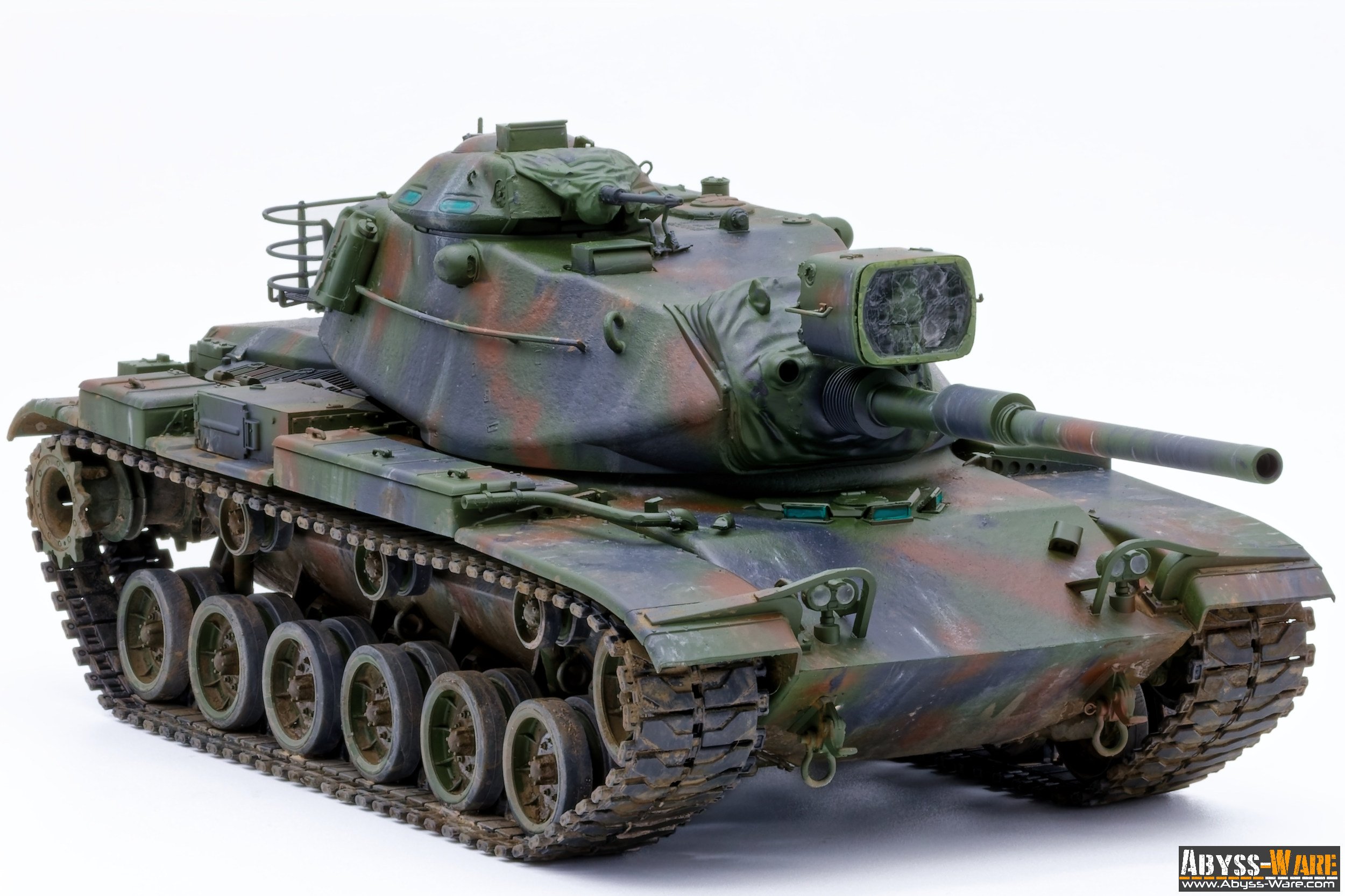 A model of a military tank painted in camouflage colors on a white background.