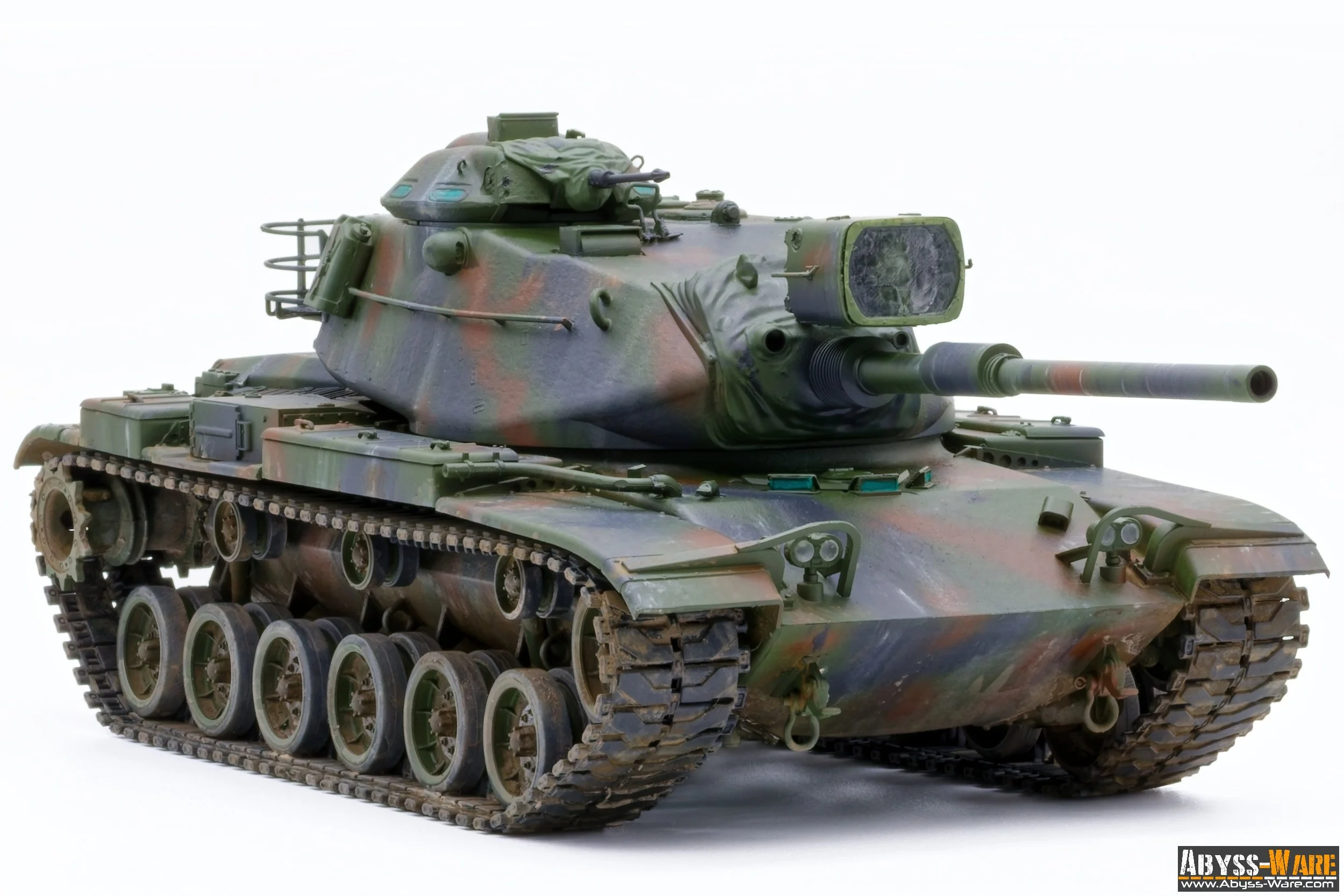 A military tank in camouflage colors with a large gun barrel, positioned on tracks, against a white background.