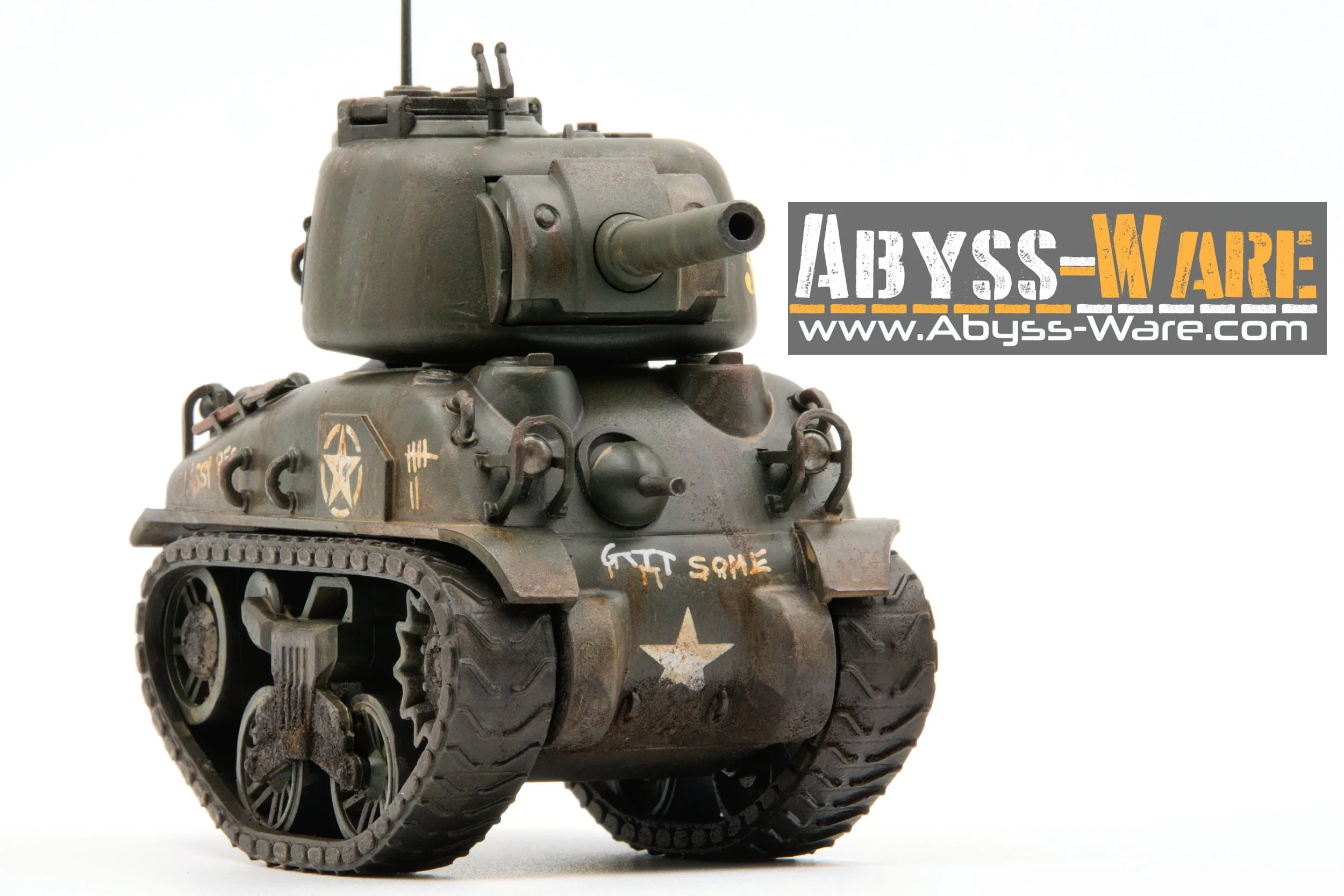 Miniature model of a military tank with treads, painted in a weathered, military style, with markings and text, and a sign reading "ABYSS-WARE www.Abyss-Ware.com" attached to it.
