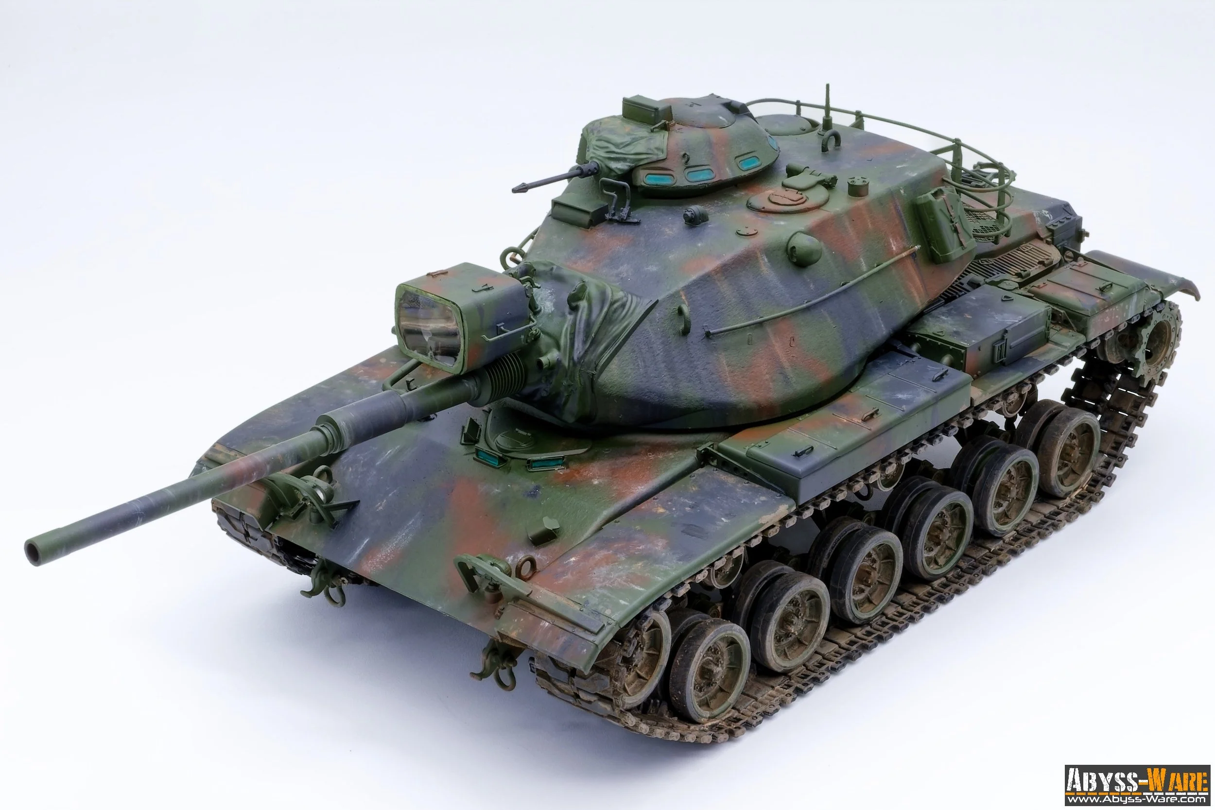 Model of a military tank painted in camouflage colors on a white background.