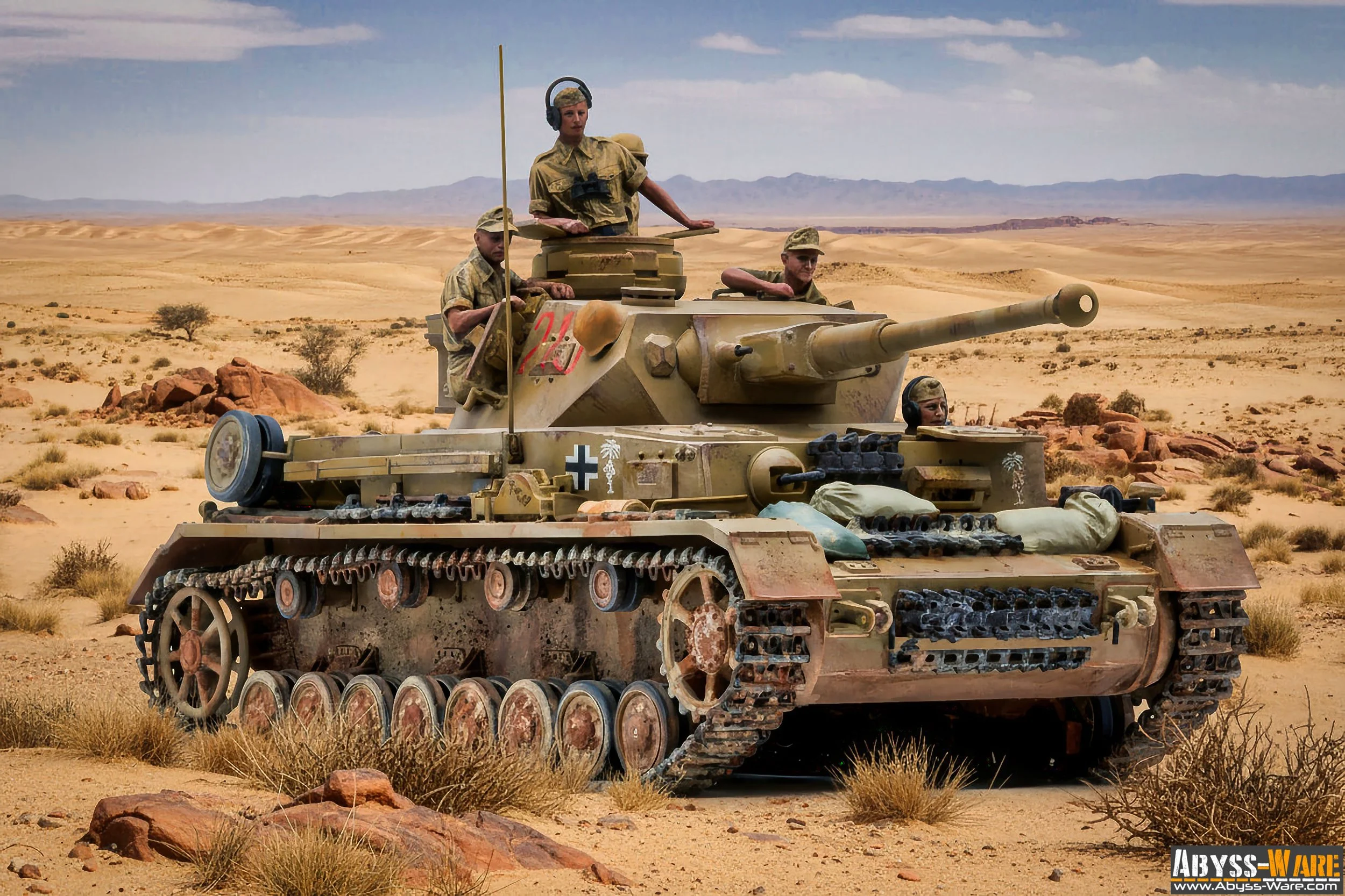 A military tank with four soldiers in a desert landscape with mountains in the background.