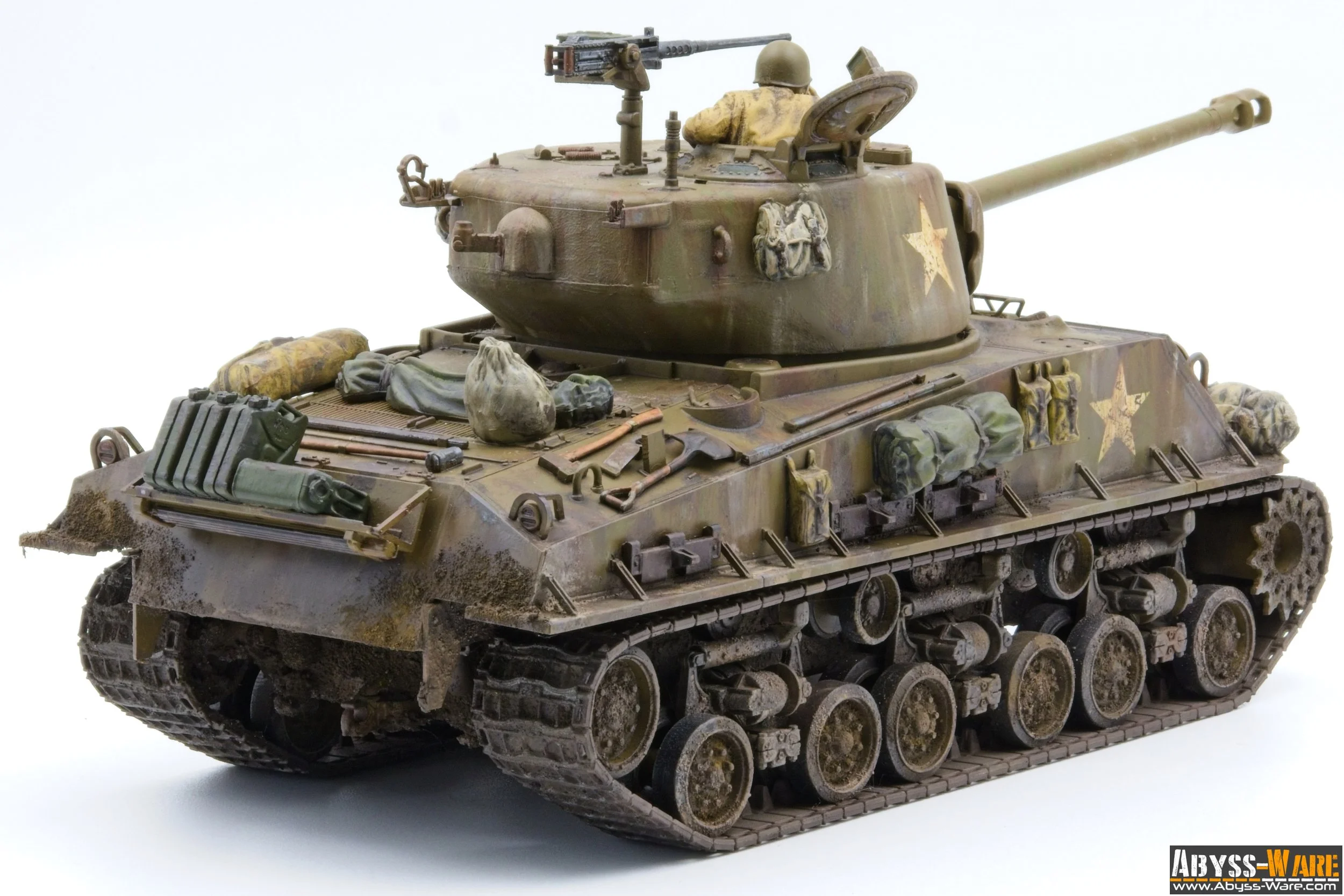 A detailed model of a military tank with camouflage paint, equipped with accessories and gear, displayed on a white background.