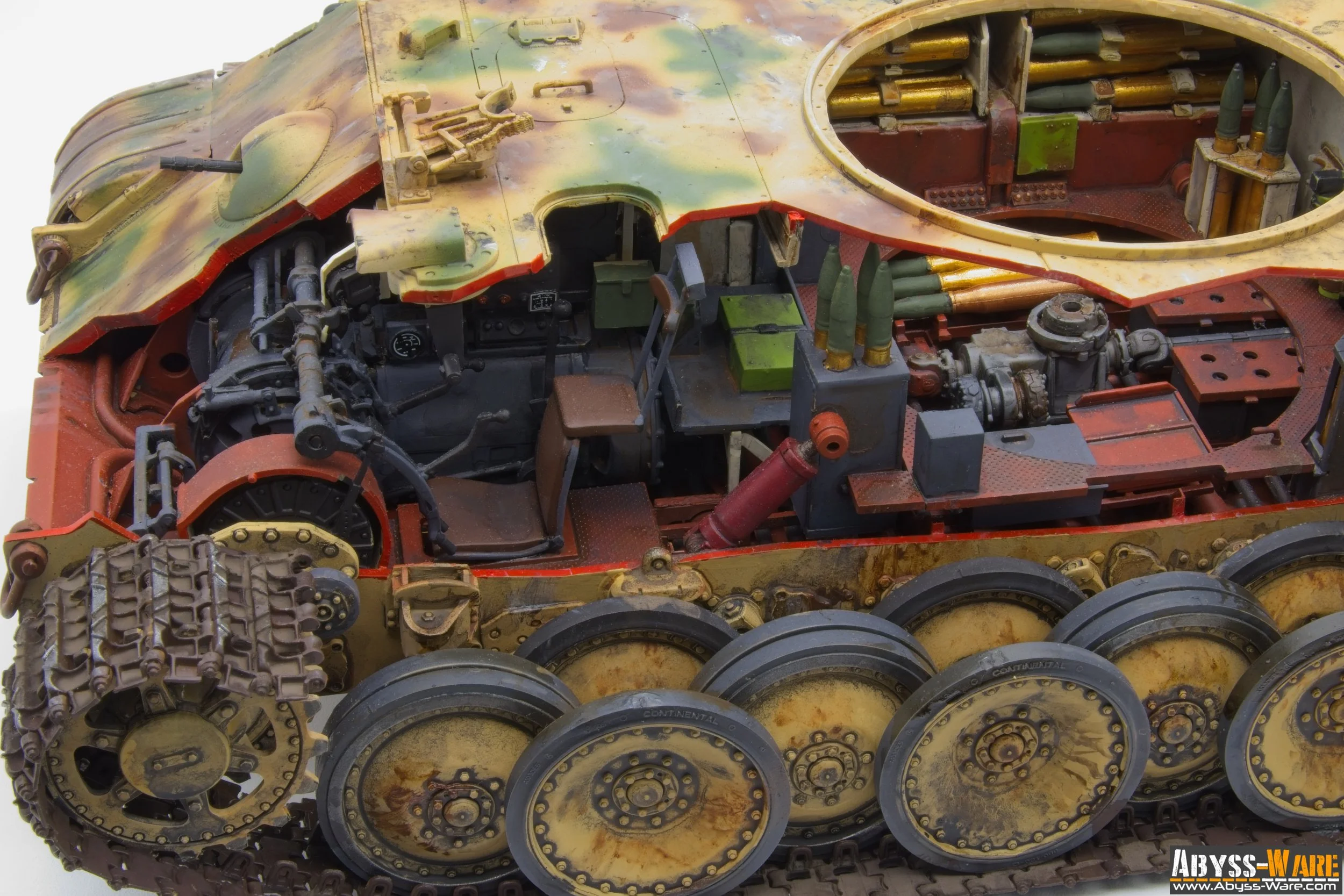 Close-up view of a detailed scaled model of a military tank's interior, showing various mechanical parts, ammunition, and control components inside the tank.