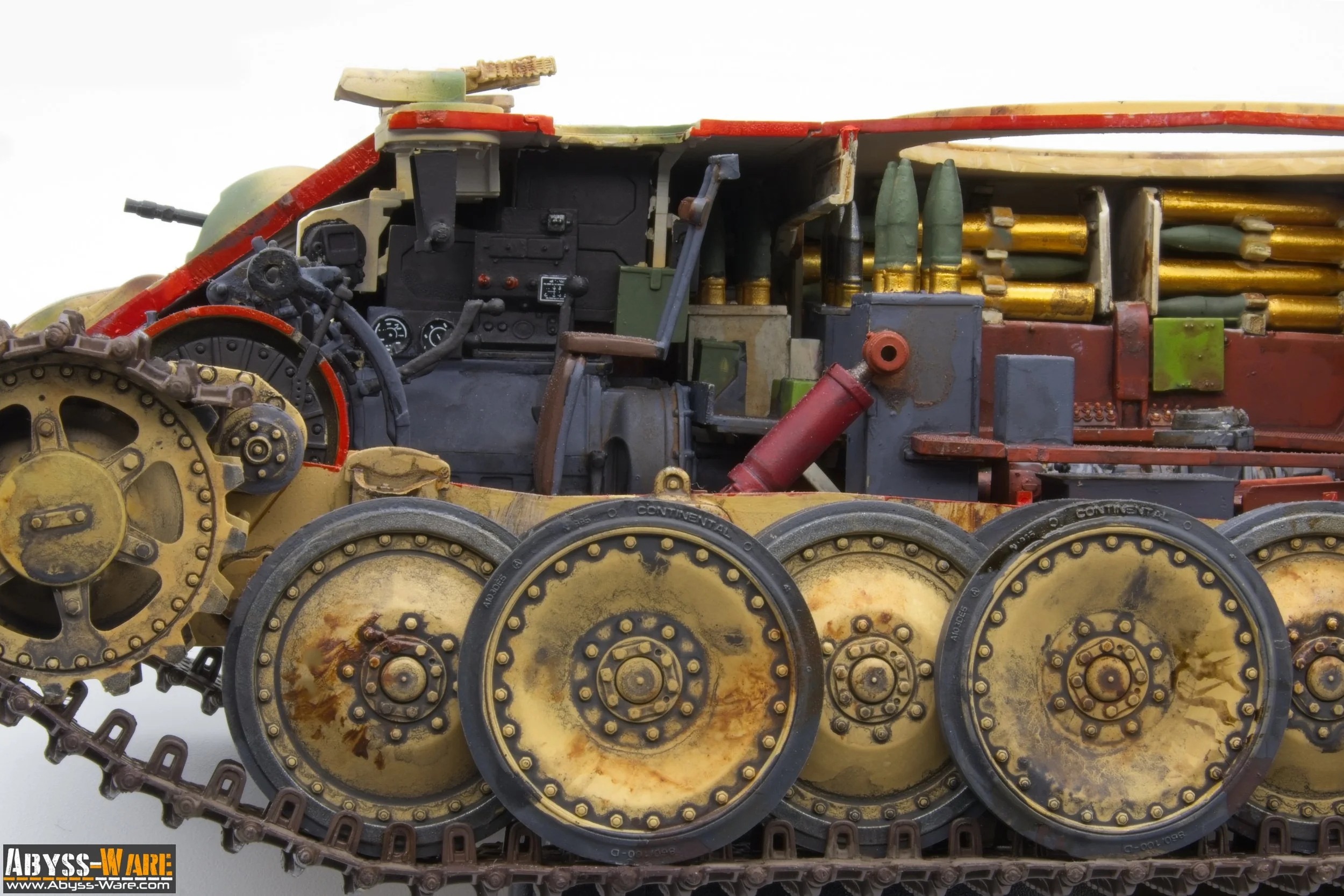 A close-up of a detailed, miniature model of a military tank showing its wheels and internal components.