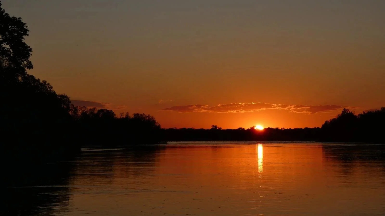 Sunrise on the Okavango River near the Angola–Namibia border, source of the waters that form the Okavango Delta.
