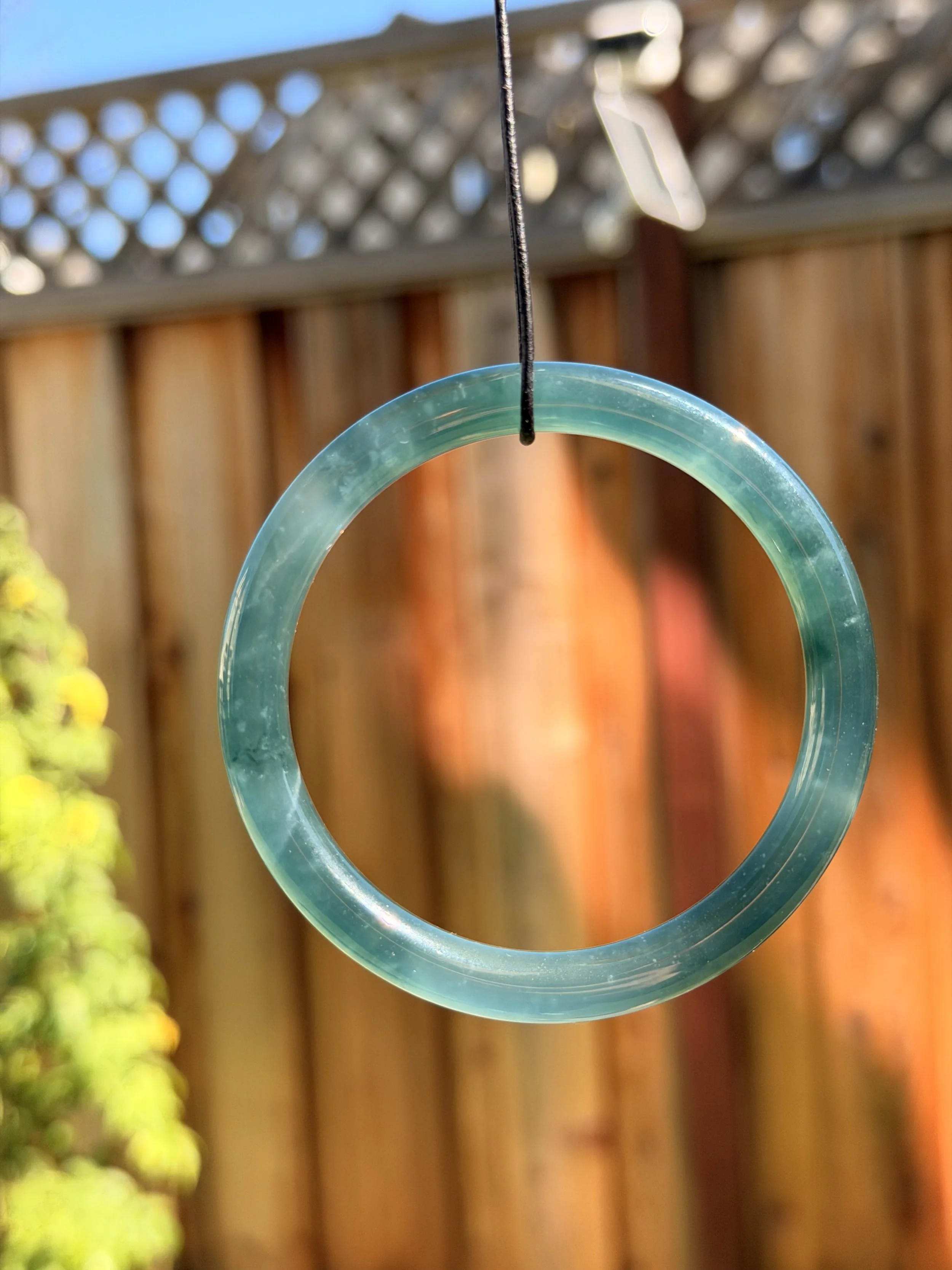 Beautiful blue water type A jadeite jade bangle outdoor showing its translucency and glow