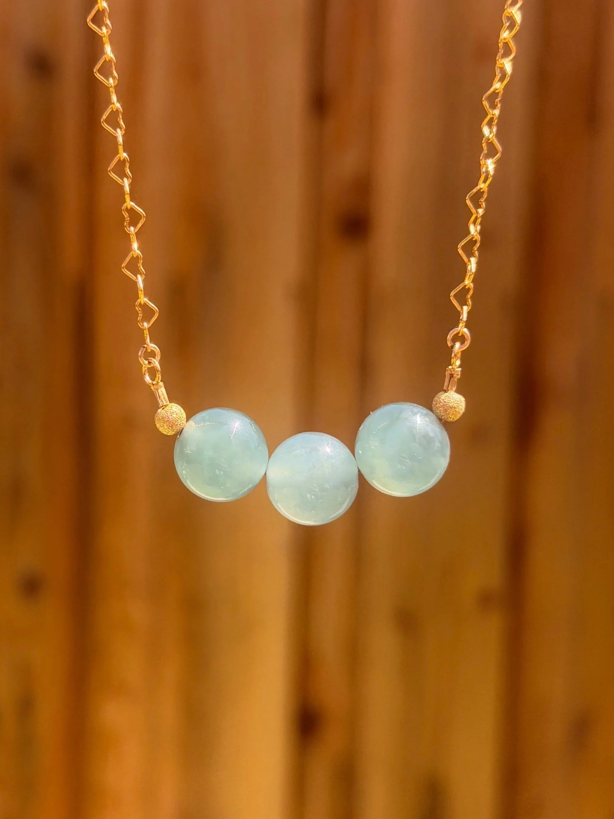 Handcrafted Guatemalan Blue Water Jadeite Necklace, Type A Grade, 12mm beads in Aura Trinity Arrangement with 14K gold filled stardust accents, 18-inch fine jewelry by ClingGem California.