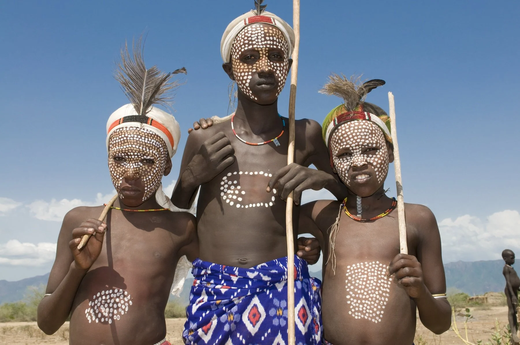 Young boys dressed in traditional clothing and body painting from the Arbore Tribe, Omo Valley, Ethiopia, Africa.