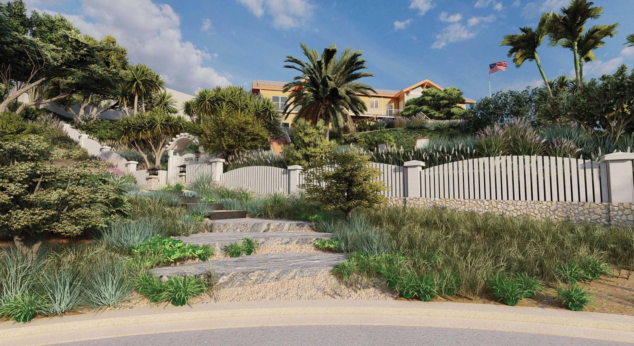 A landscaped hillside with various plants, trees, and shrubs, leading up to a white fence and large house at the top, with an American flag and blue sky in the background.