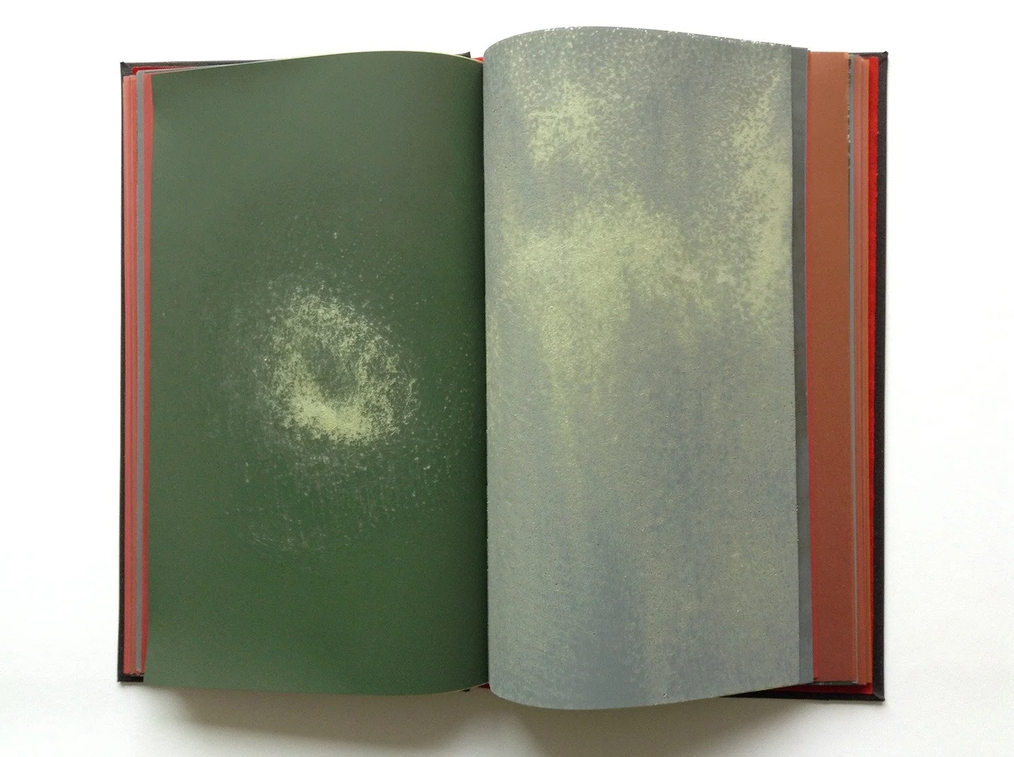  Spread from the book; left page is hand sanded chromium oxide microfinishing film; right page is hand sanded silicon carbide microfinishing film. 