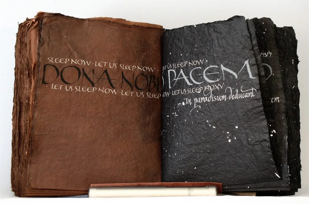  Inside page of brown and black paper with Mass, Wilfred Owen poem. 