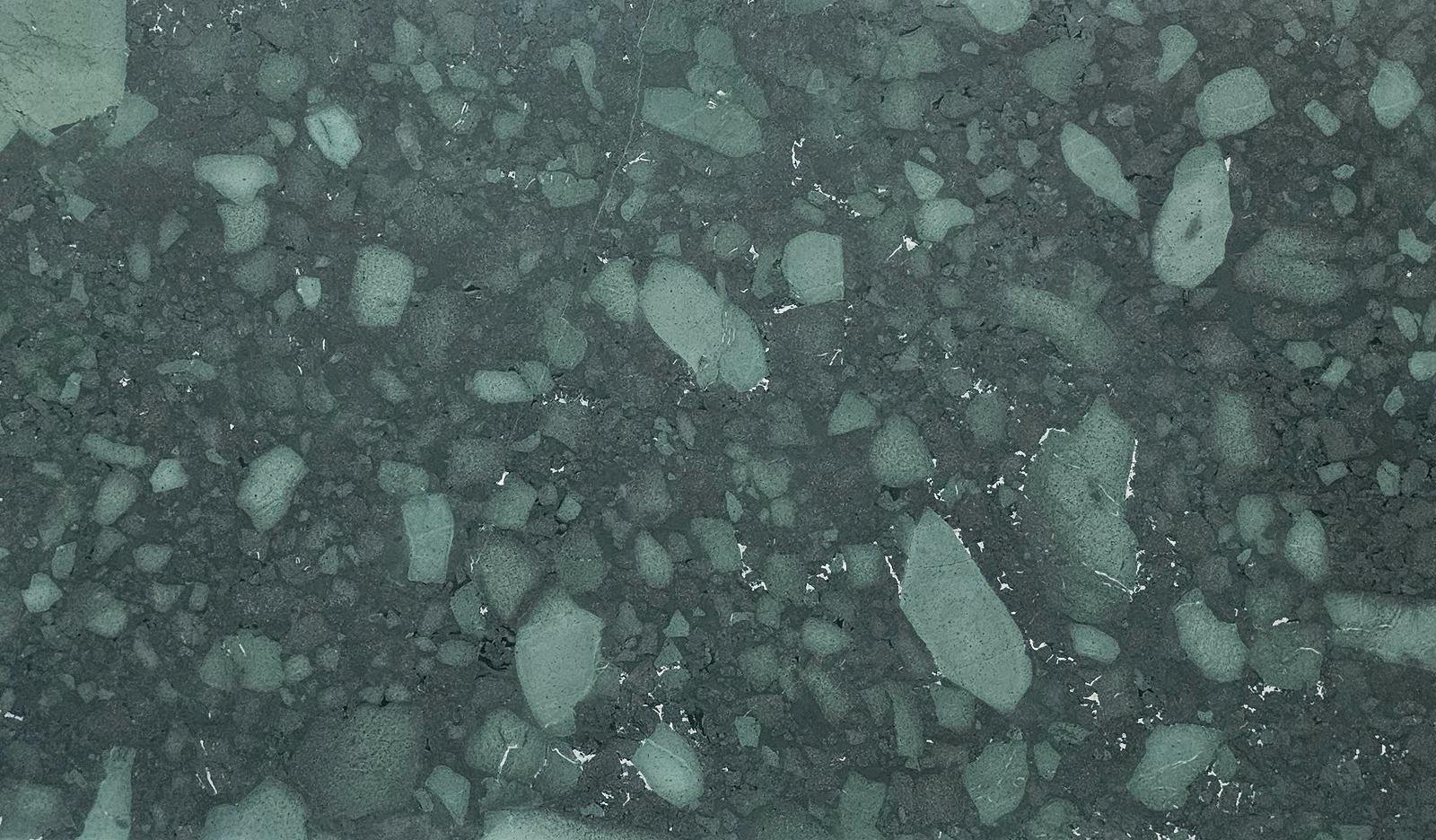 Close-up of dark gray gravel and rocks on a surface.