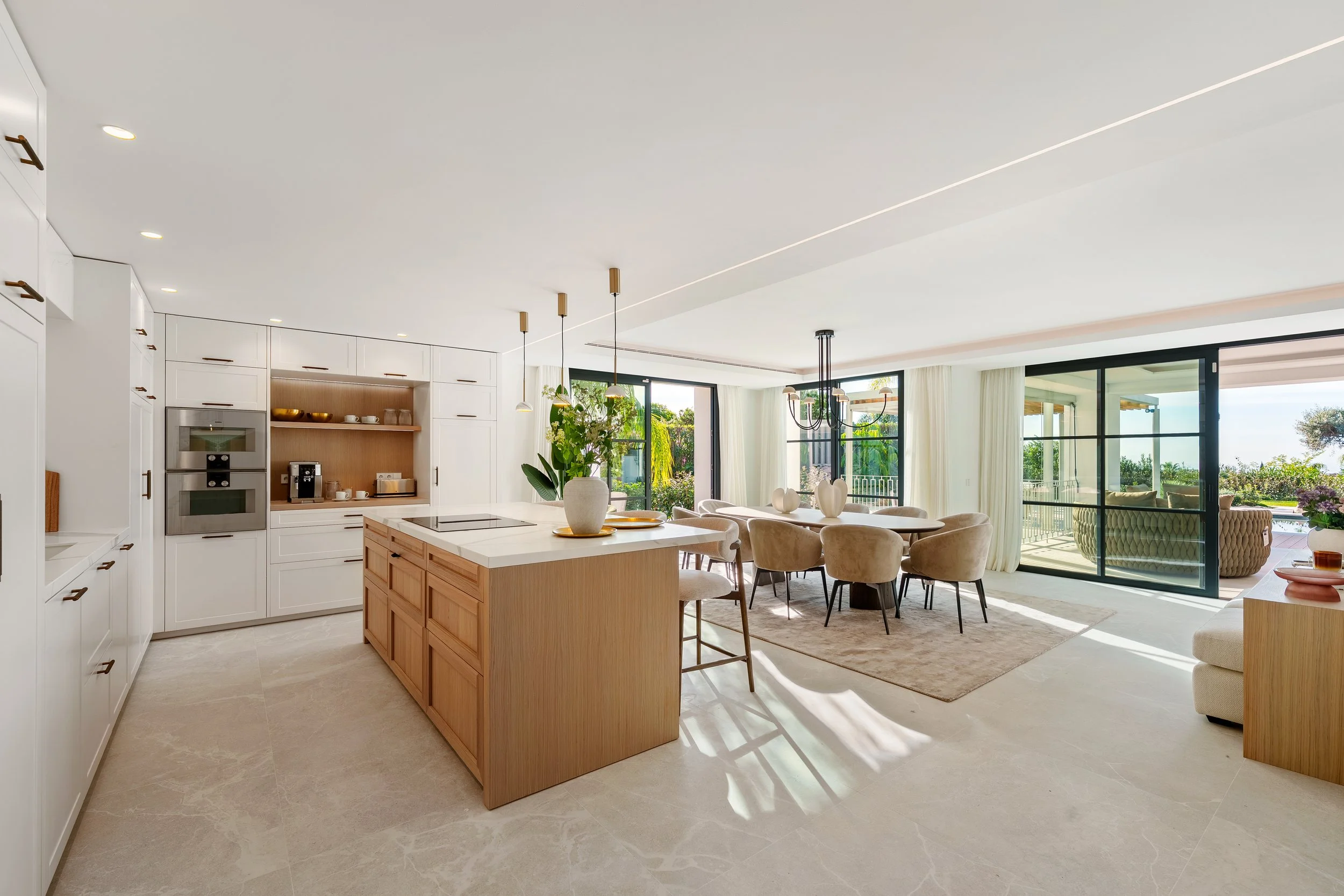 Gourmet Kitchen: The minimalist kitchen island with natural wood cabinetry and high-end stone countertops, designed for the culinary enthusiast.
