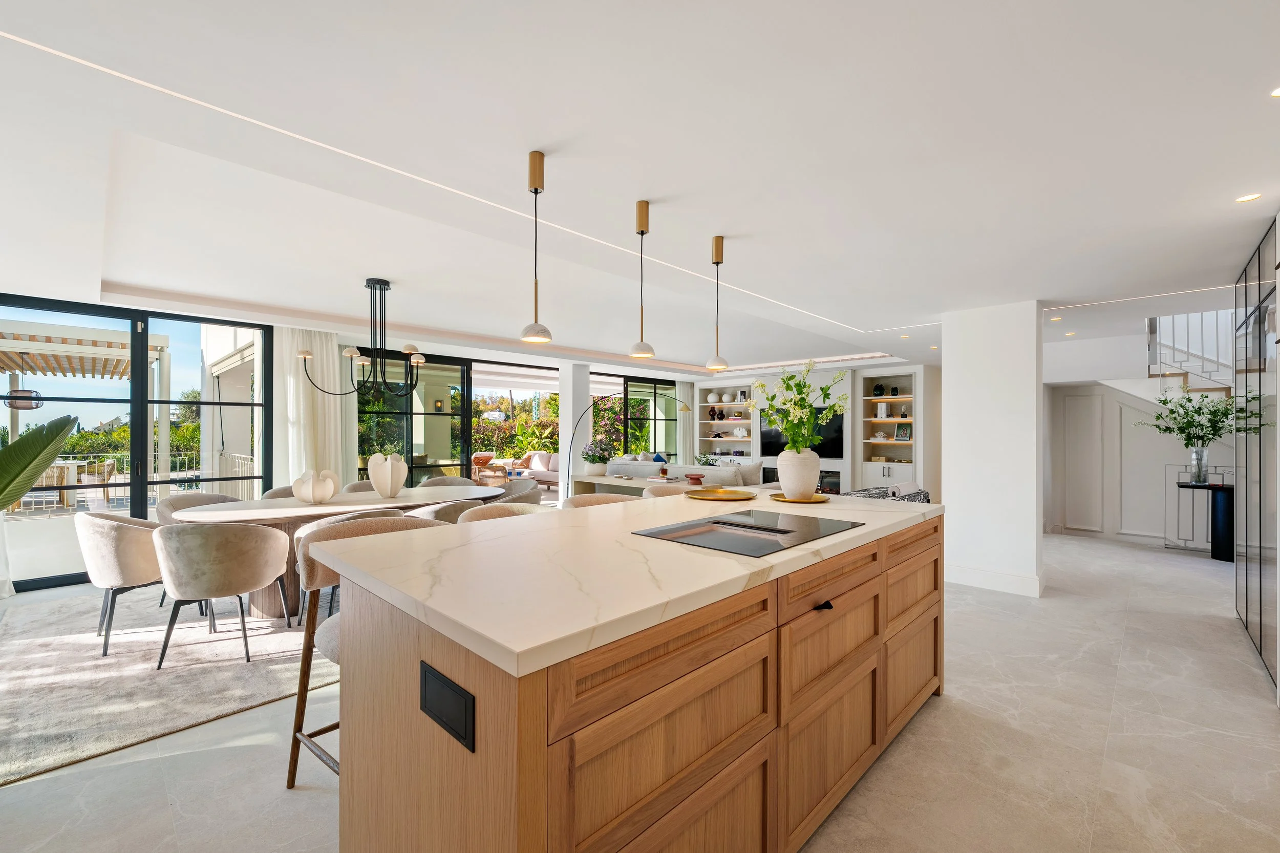 Dining Space: A sophisticated dining area integrated into the open-plan layout, illuminated by soft, modern architectural lighting.