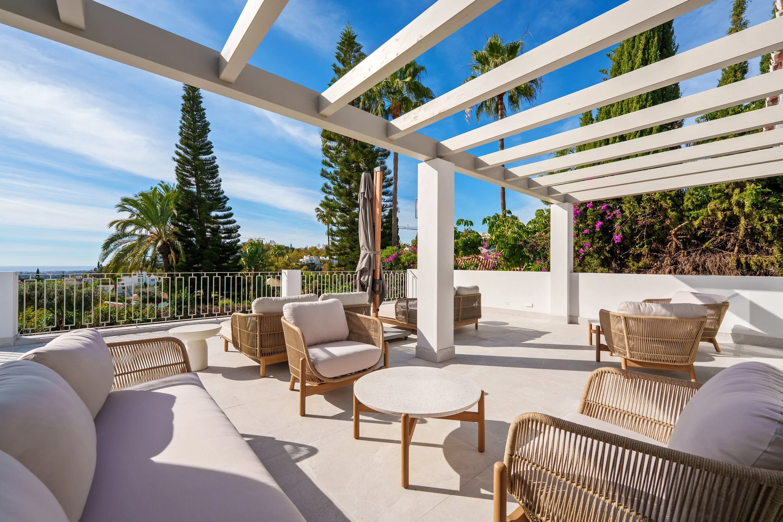Outdoor Pergola: A close-up of the architectural white pergola, offering a shaded sanctuary for al fresco dining.