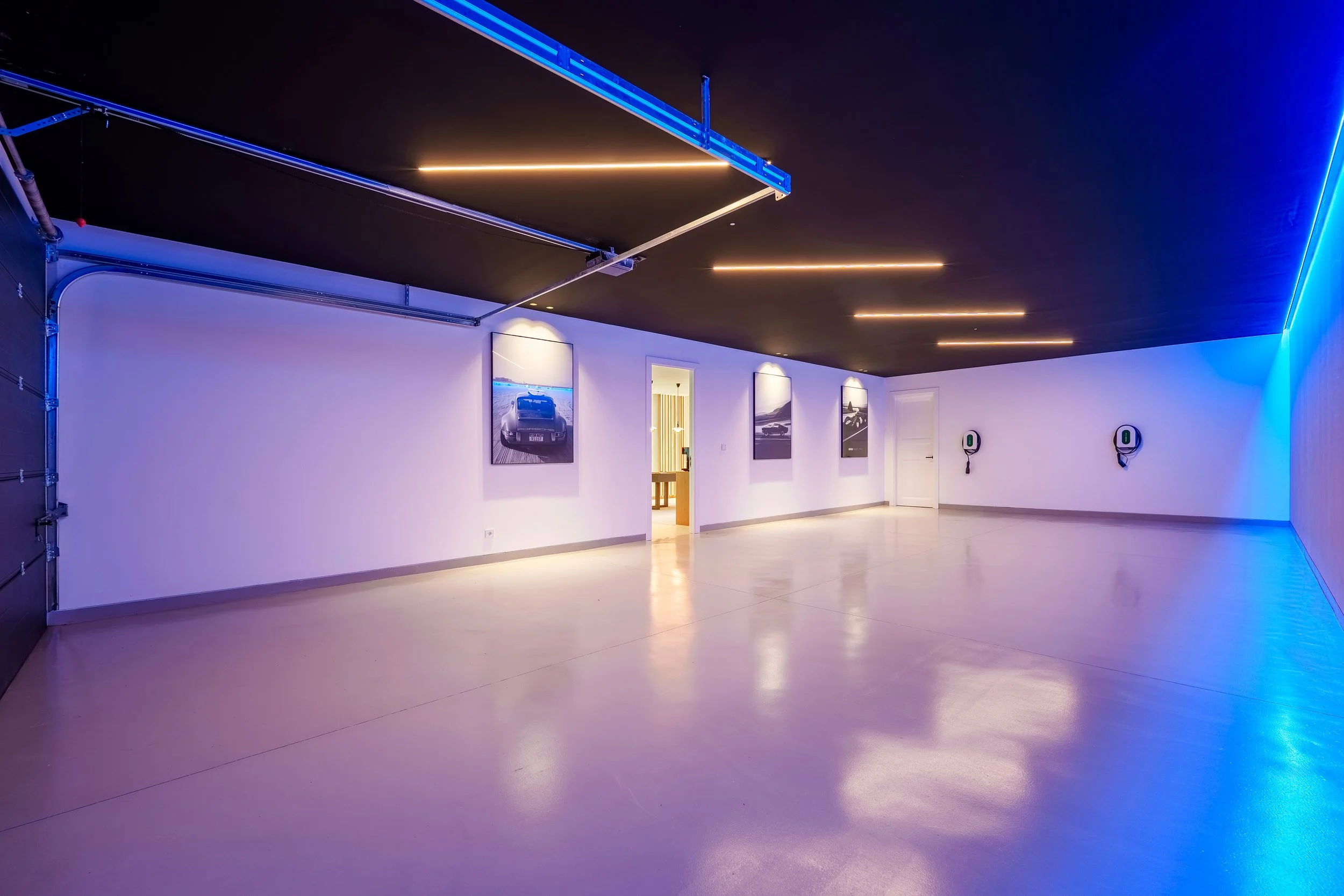 A sleek, modern garage space with stylized lighting and ample room for high-end vehicles