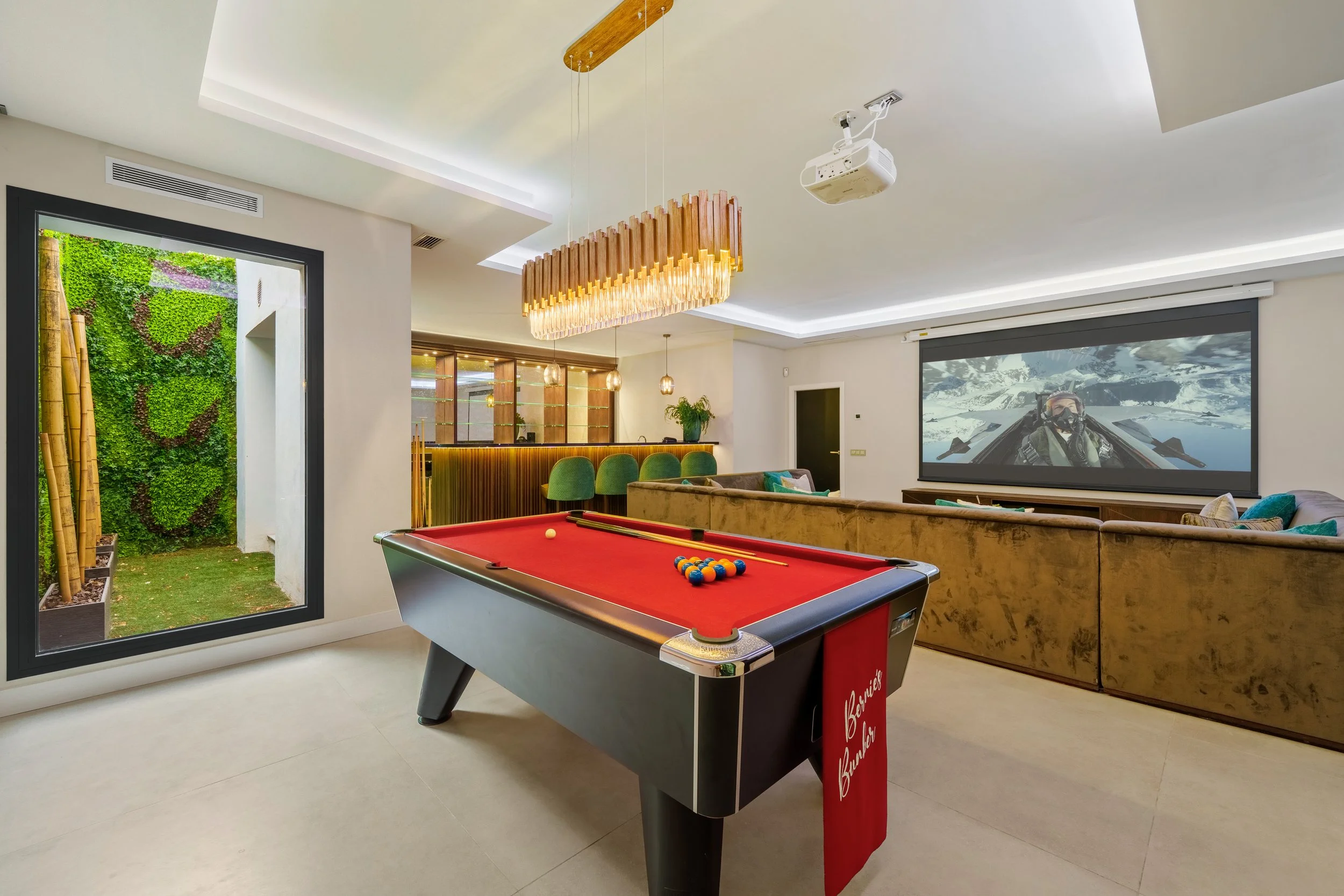 Entertainment lounge featuring a red-felt pool table and high-tech lighting.
