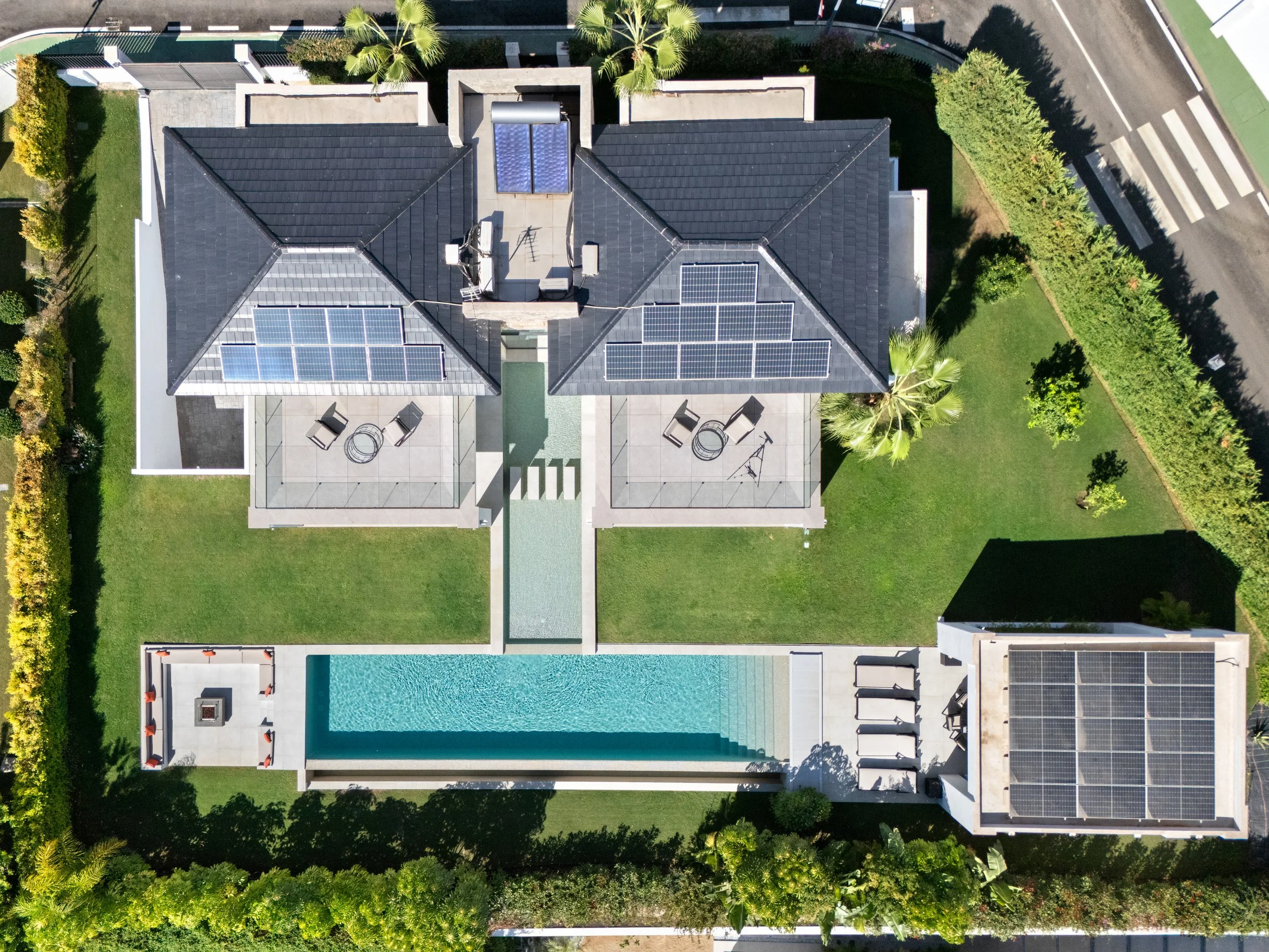 Top-down aerial view of the property highlighting the integrated solar panel system and garden layout.