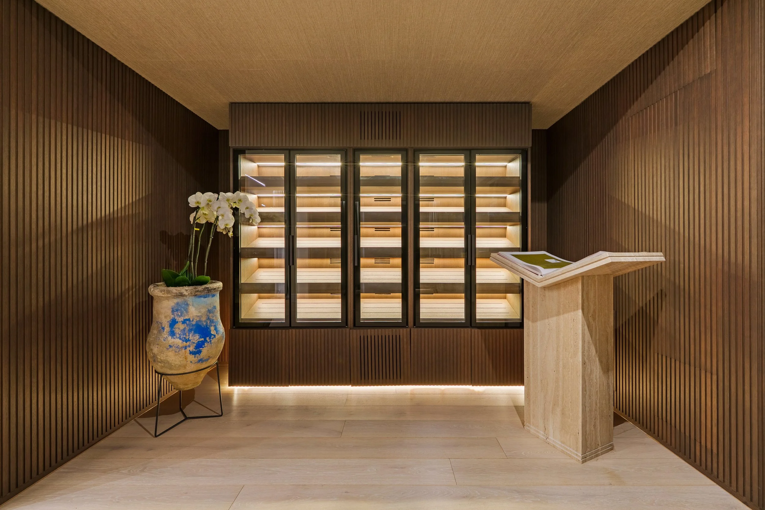 Custom climate-controlled wine cellar with integrated lighting and minimalist wood finishes