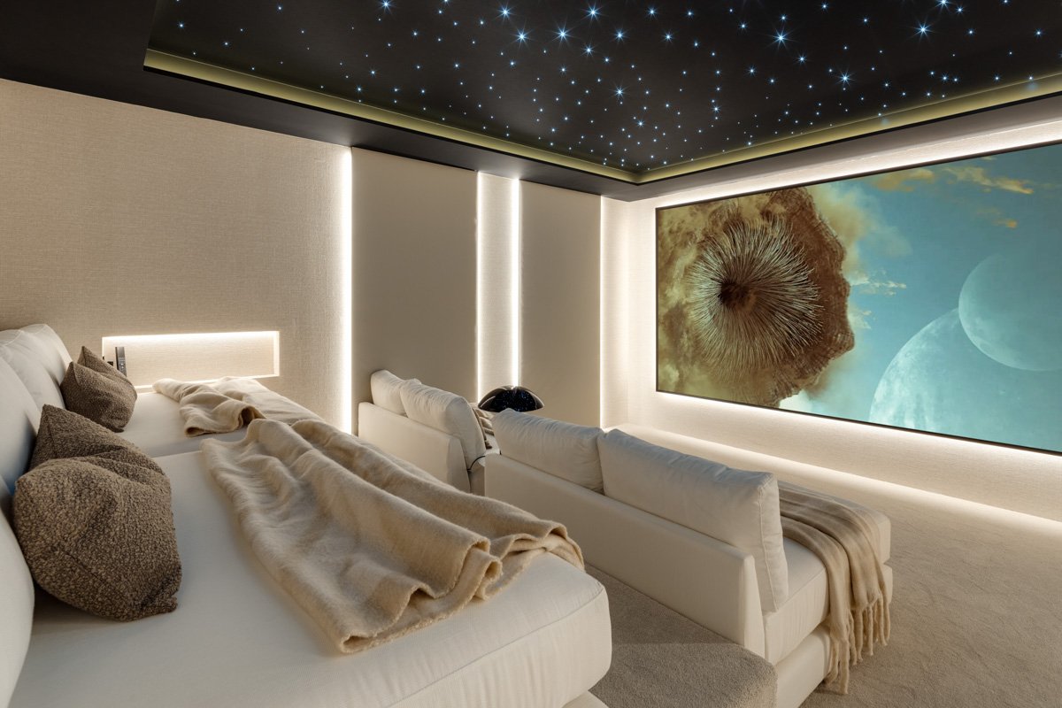 High-tech home cinema with tiered seating and a starlight ceiling for a private movie experience