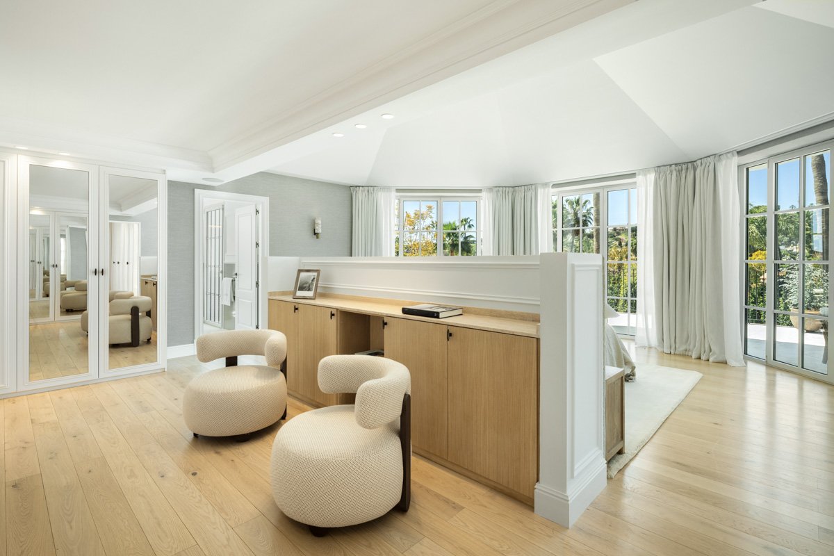 Luxurious primary suite featuring a private seating area and built-in vanity in Nueva Andalucia.