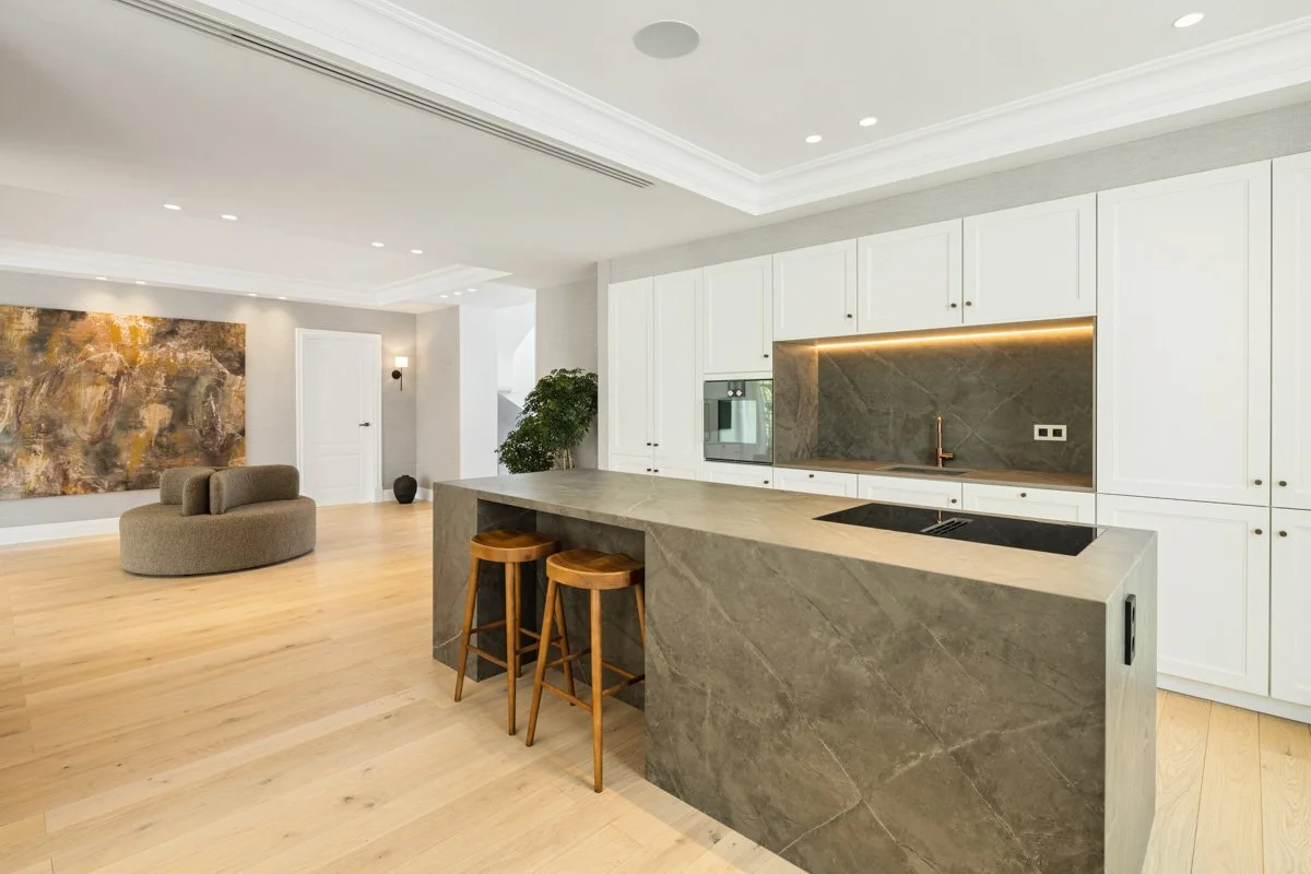 Modern custom kitchen with large stone island and high-end integrated appliances in villa CMH614563S