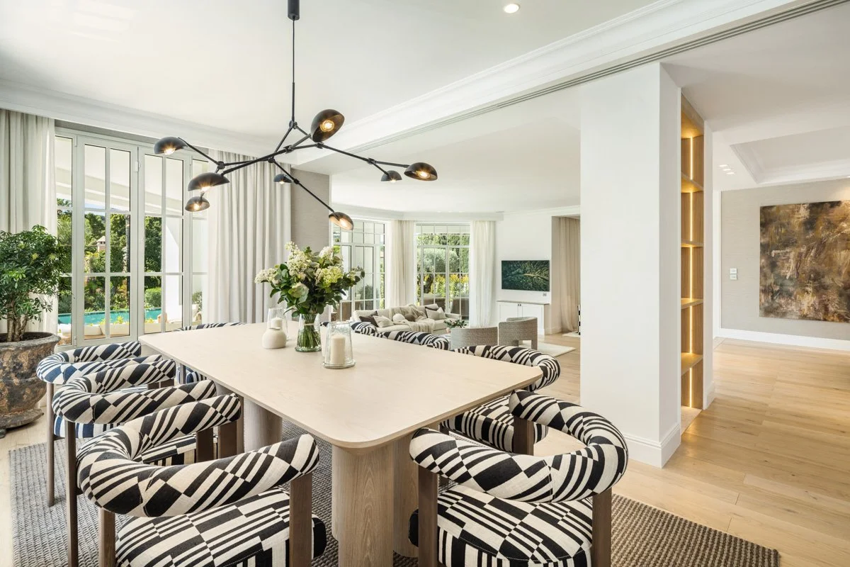 Sophisticated dining area with designer furniture and views of the lush gardens in Marbella