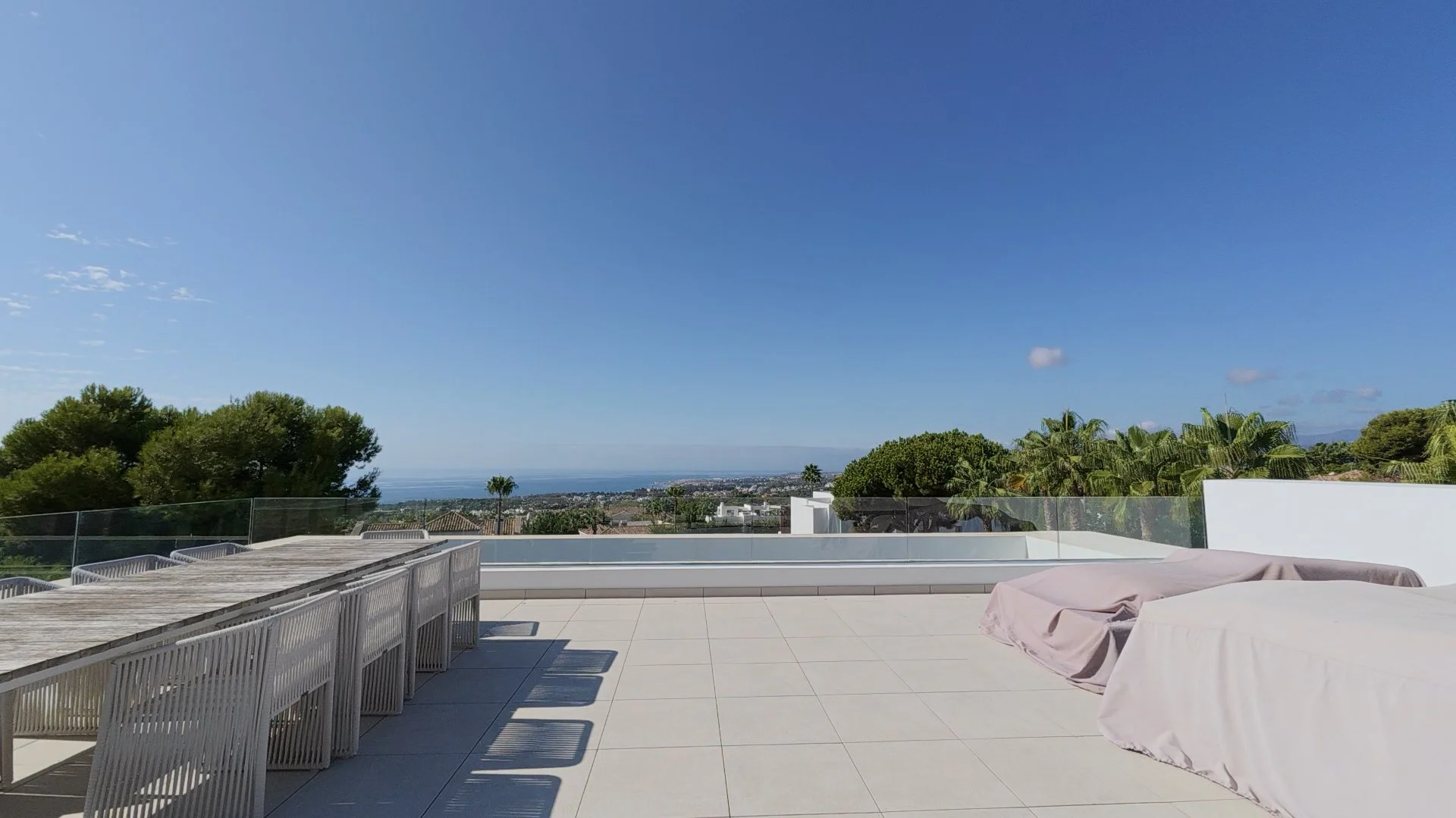 Private perspective from the rooftop terrace showing the built-in lounge area and panoramic coastal views, a key moment from the Open House tour.