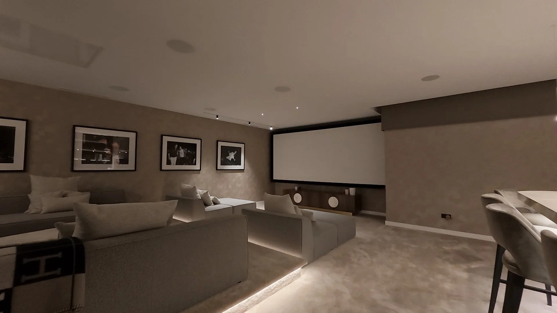 Walk-through of the private cinema room showing high-end seating and large projection screen.